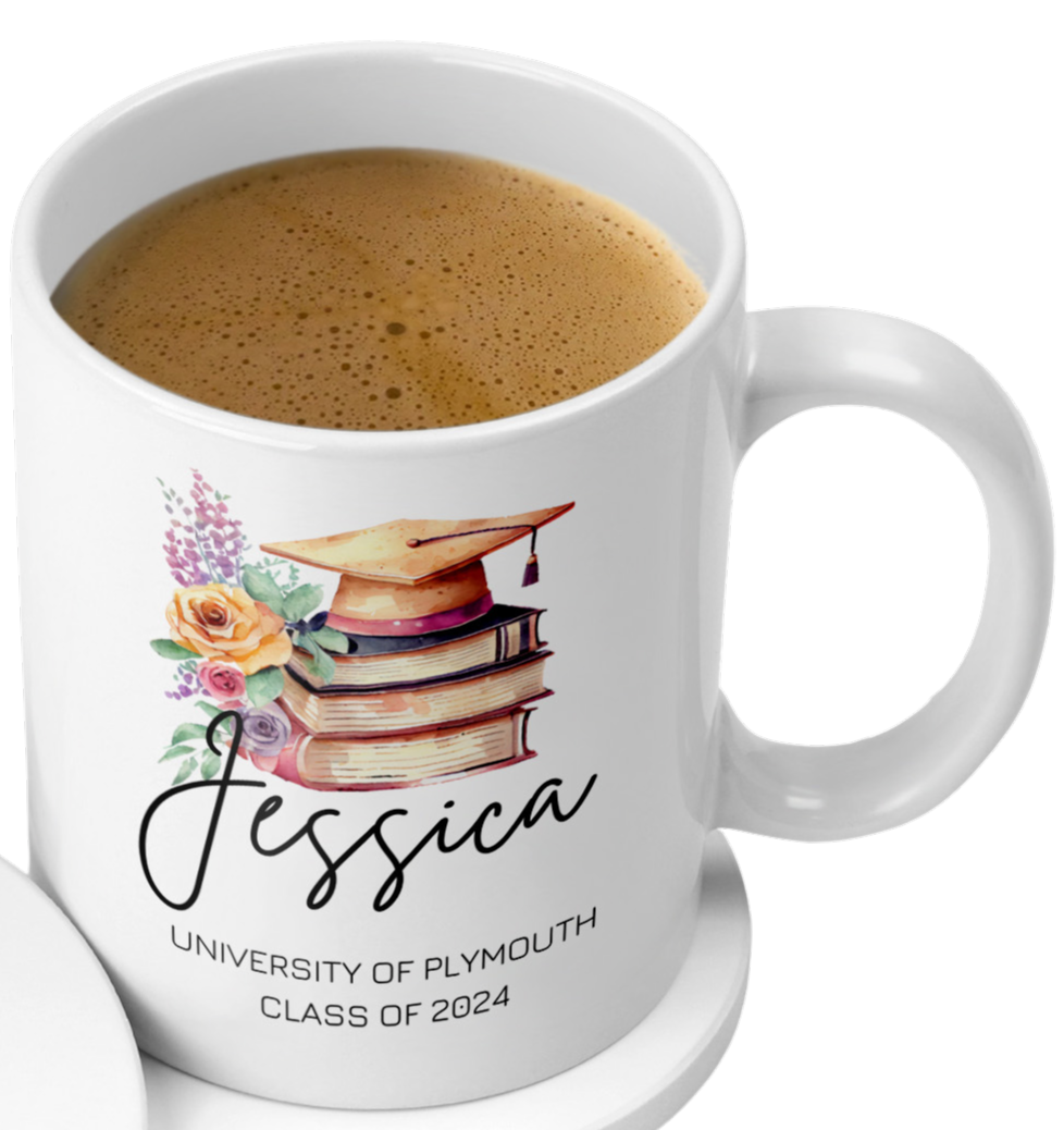 A white ceramic mug filled with coffee, featuring a watercolor illustration of a gold graduation cap resting on a stack of books with floral accents. Below the design is the name "Jessica" in a black script font, followed by the text "University of Plymouth, Class of 2024" in uppercase sans-serif font. The mug is placed on a matching white coaster on a light wood background.