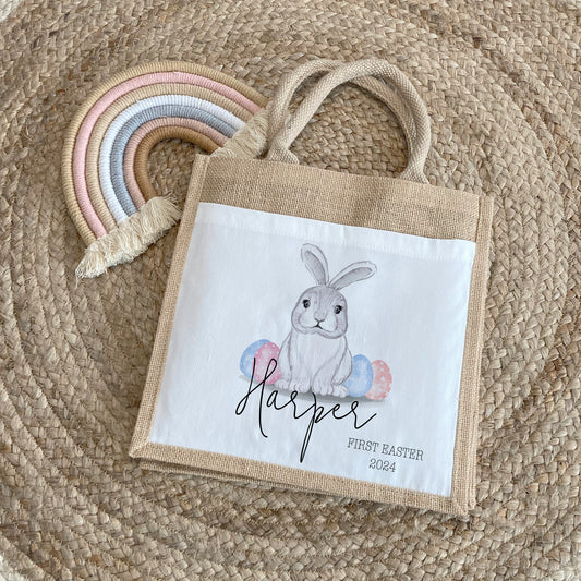 Unique personalised jute Easter bag featuring a cute bunny with pastel eggs and the name “Harper” with “First Easter 2024” – a thoughtful keepsake gift for baby's first Easter celebration.