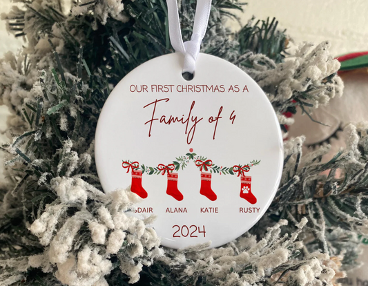 Personalised Christmas tree ornament with 'Our First Christmas as a Family of 4' text, red stockings, custom names, and year 2025