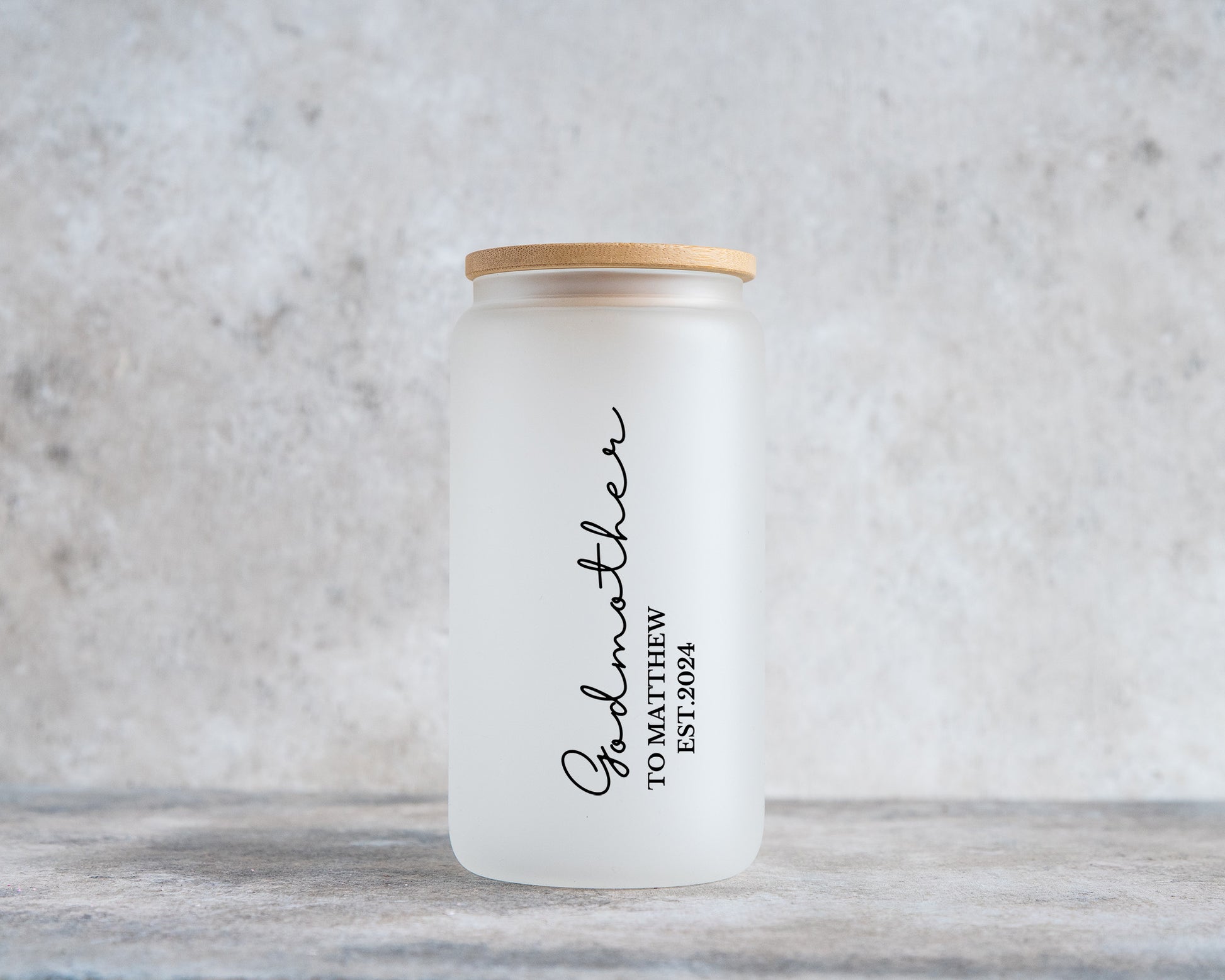 Frosted glass tumbler with a bamboo lid, printed vertically with the phrase “Godmother to Matthew EST. 2024” – a personalised gift ideal for a godmother announcement or christening keepsake.