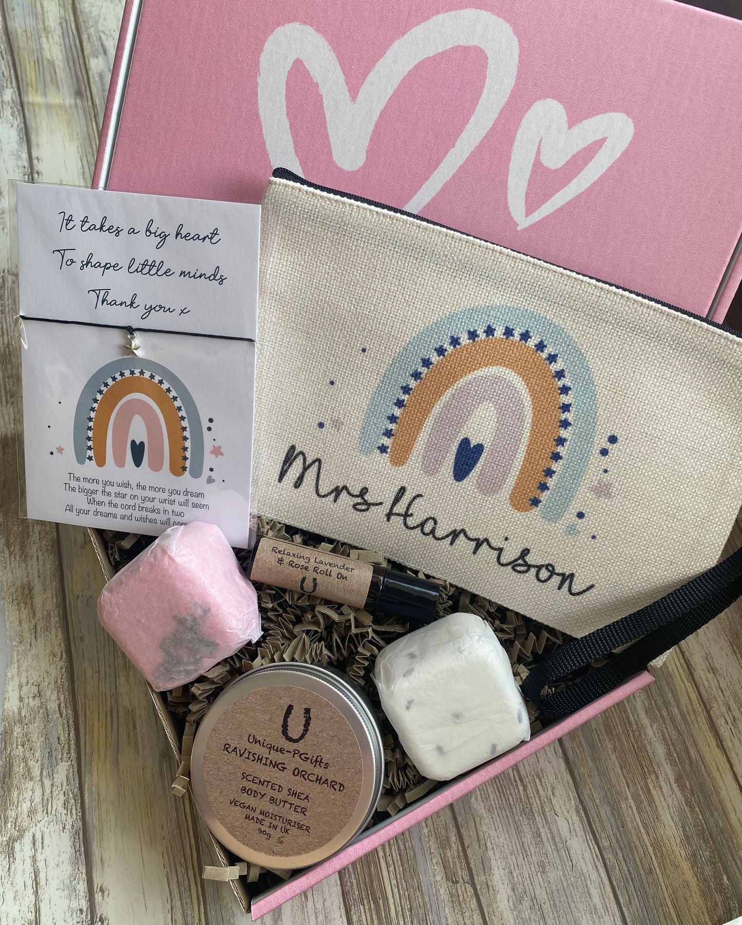 Personalised Teacher Hamper, Teacher Gift, pink gift box, fully open, showcasing the "Mrs Harrison" pouch, star charm bracelet, oil, bath melts, and body butter neatly arranged inside.