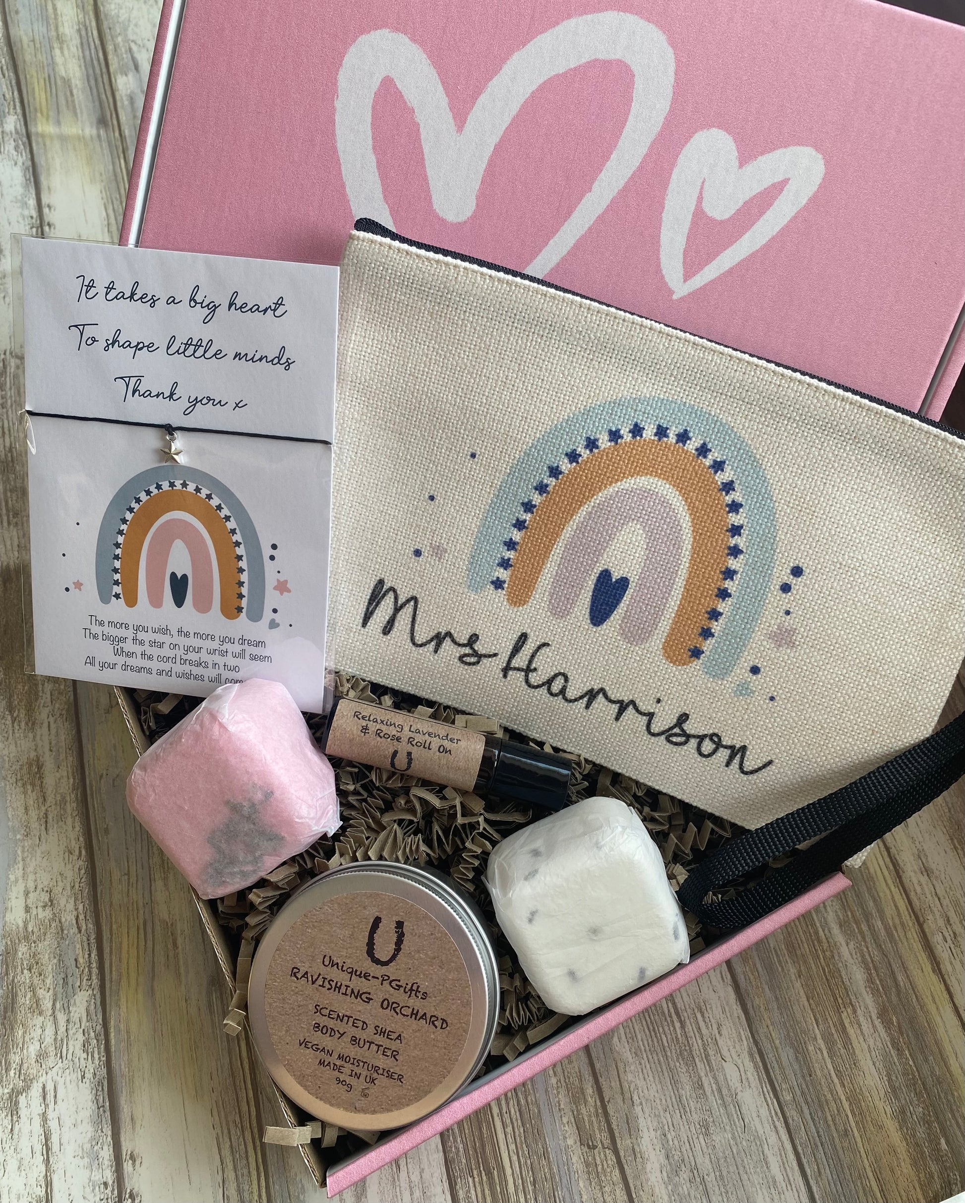 Personalised Teacher Hamper, Teacher Gift, pink gift box, fully open, showcasing the "Mrs Harrison" pouch, star charm bracelet, oil, bath melts, and body butter neatly arranged inside.