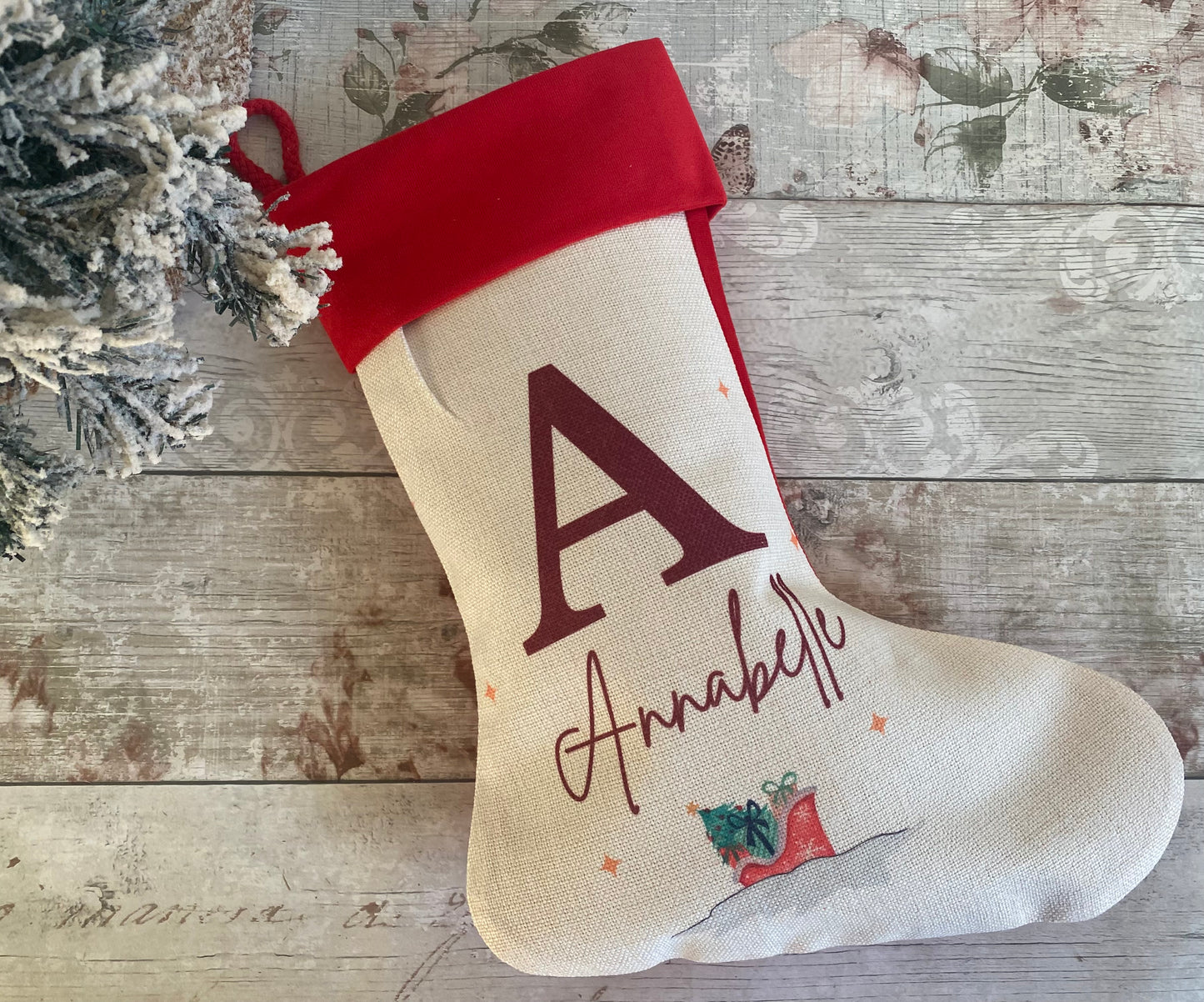 Personalised Christmas stocking for child named Annabelle, featuring large burgundy initial 'A', festive red boot with presents design, and bright red cuff – custom holiday stocking for kids, perfect for Christmas morning surprises.