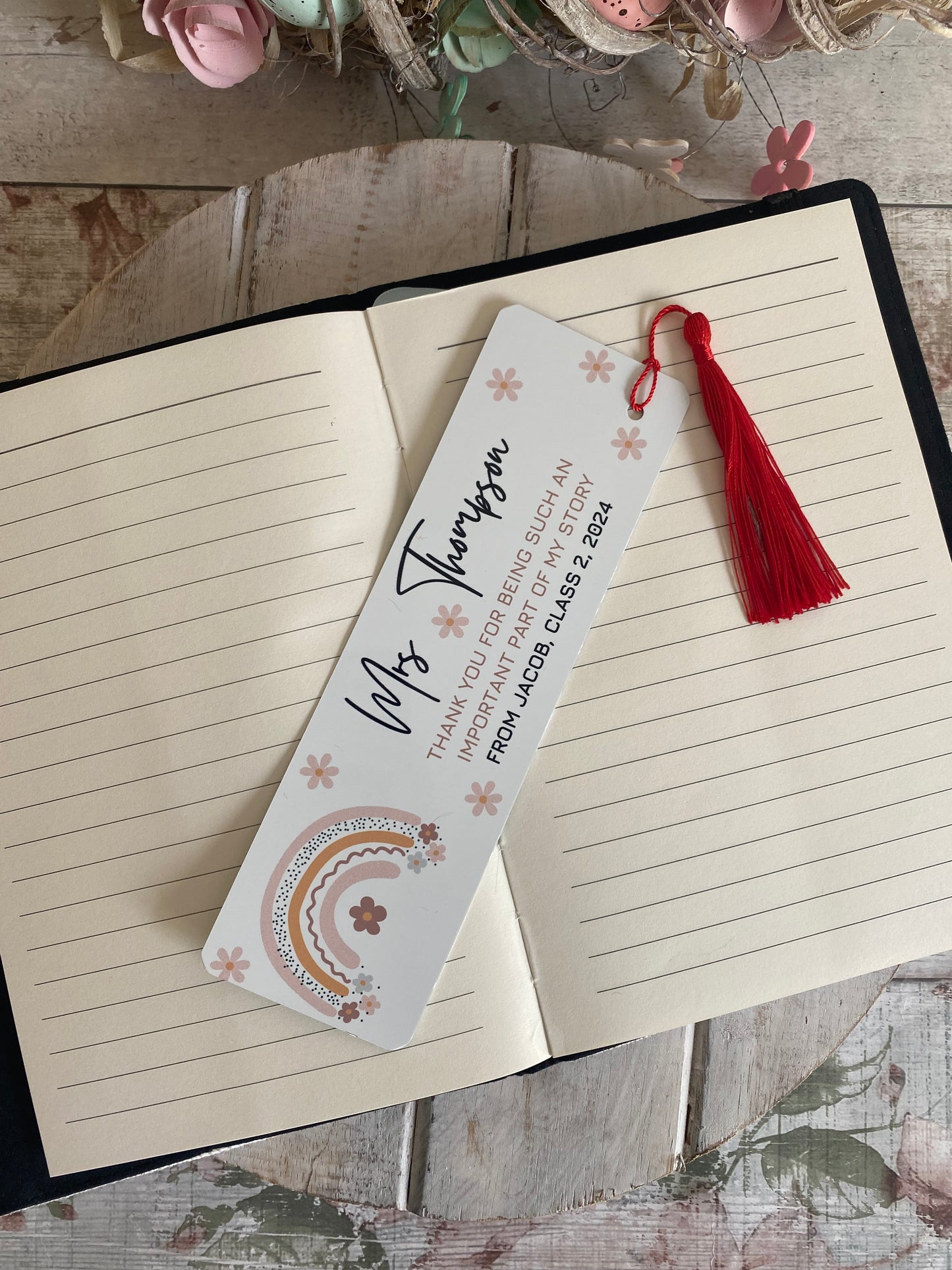 Thoughtful teacher appreciation gift – personalised bookmark for Miss Thompson with floral rainbow illustration, red tassel, and heartfelt message from Jacob, Class of 2024.