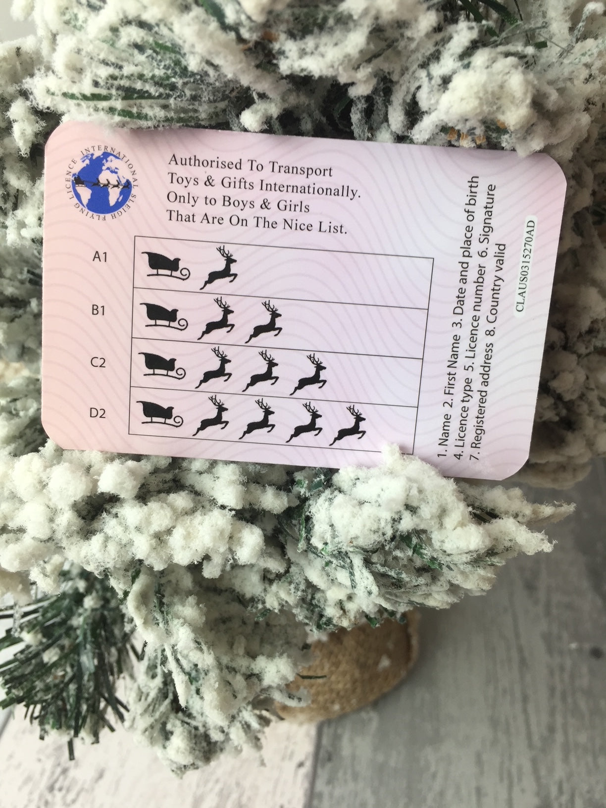 Pink card with black illustrations on a textured surface