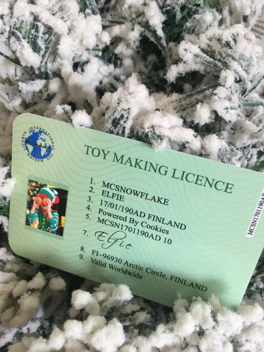 Elf Toy Making Licence card on a snowy background