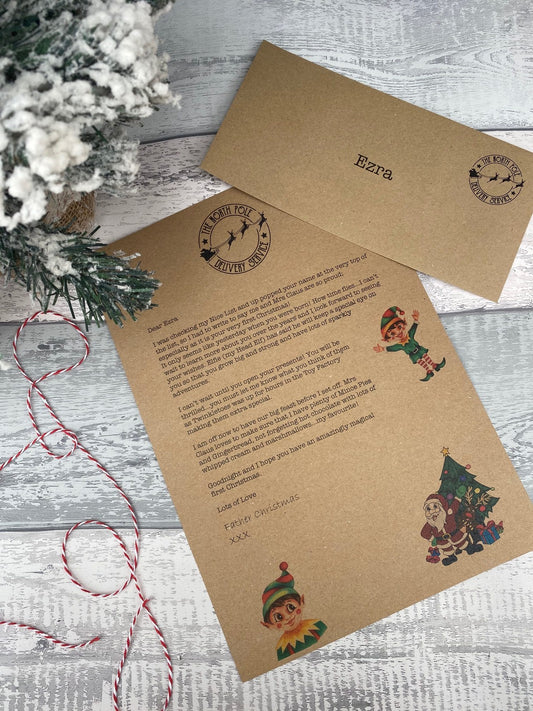 Personalised letter and envelope with Christmas-themed illustrations on a wooden surface.