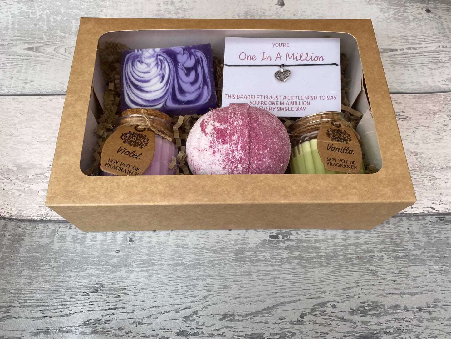 Gift set with bath bombs and soaps in a box on a wooden surface
