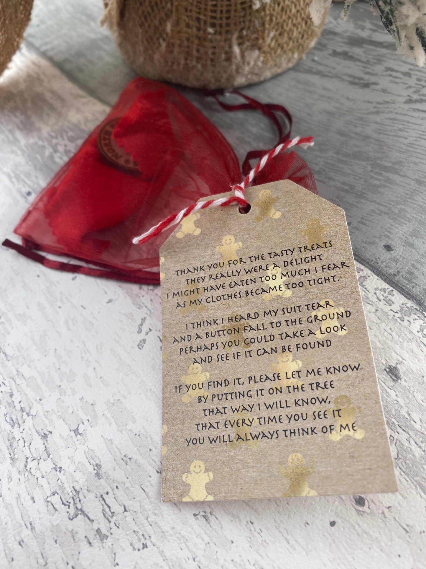 Red gift bag with a Lost Santa button and tag