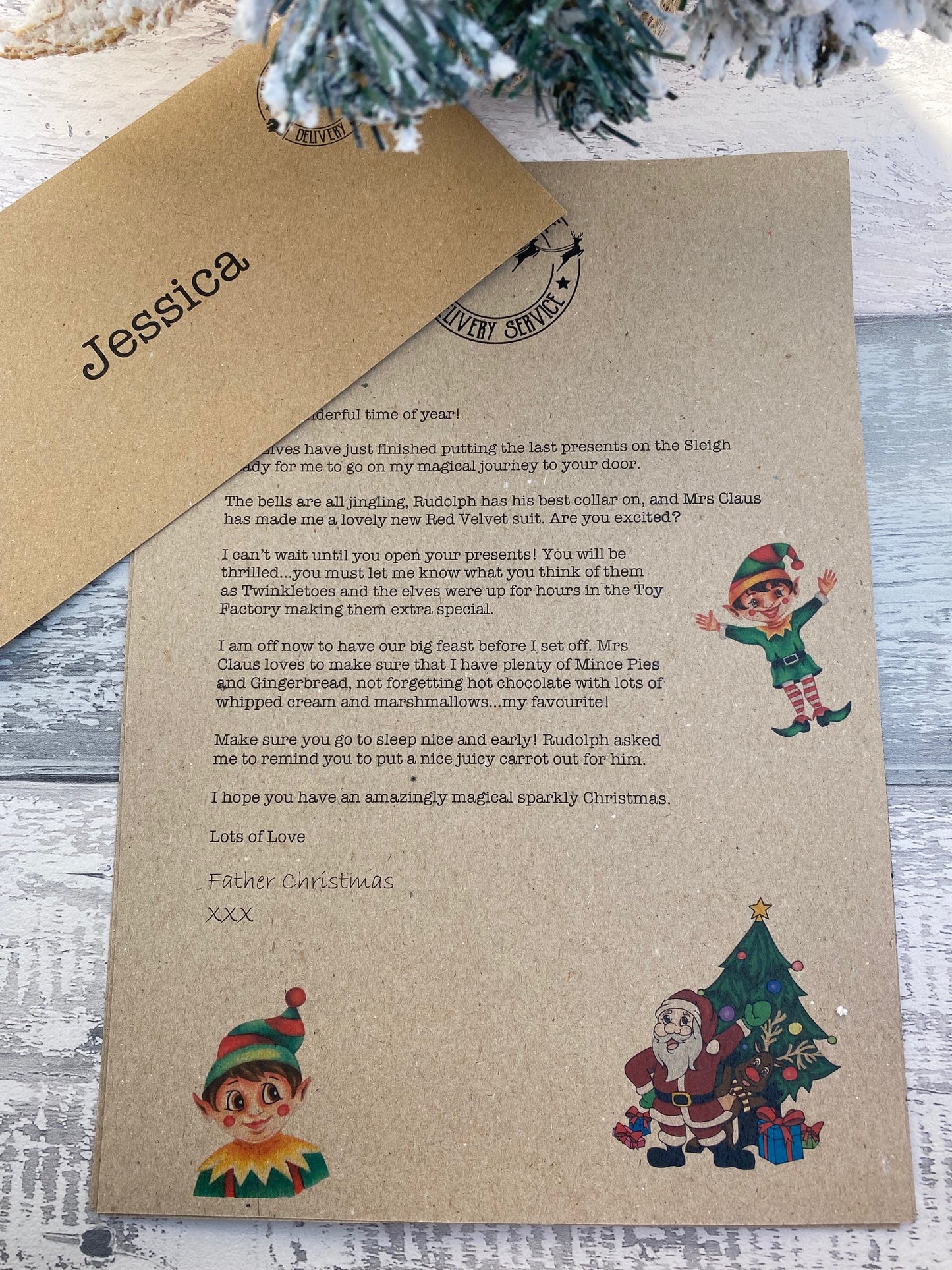 Personalised Kraft paper letter with Christmas-themed illustrations on a wooden surface