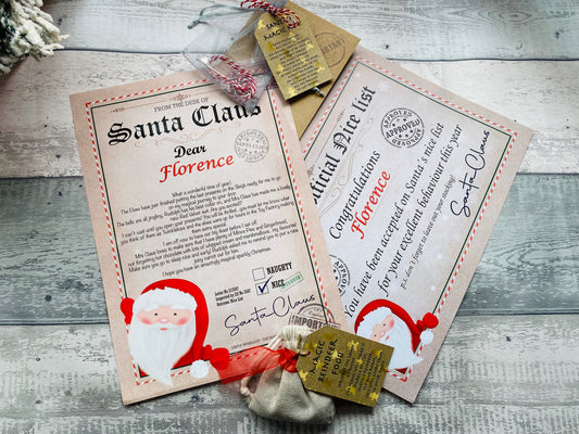 Letter from Santa Claus, certificate, reindeer food and magic key on a wooden surface