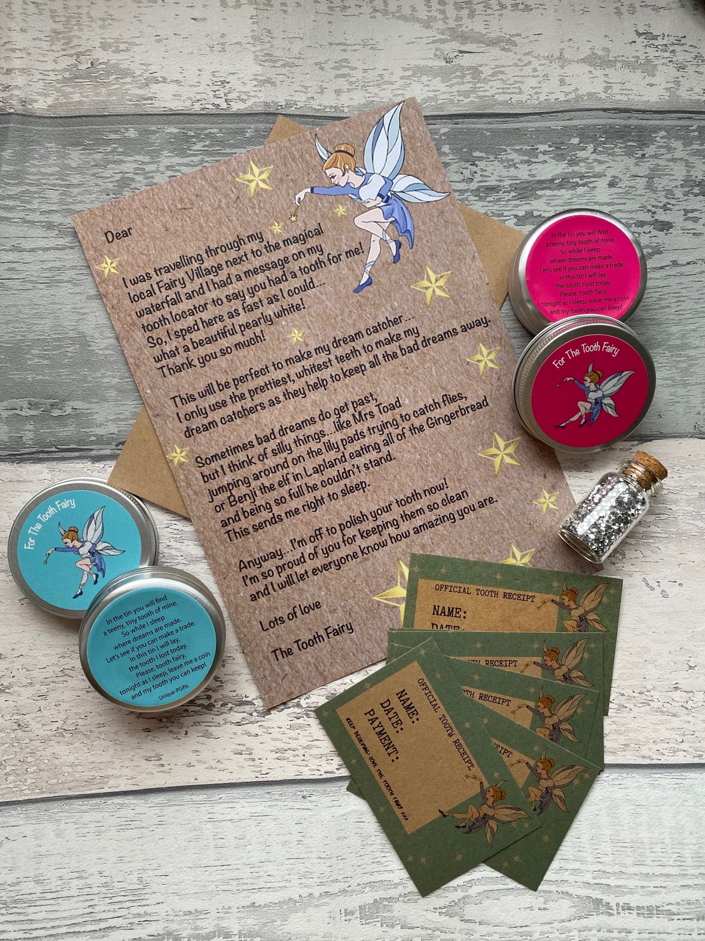 Personalised Tooth Fairy Kit. Set of tins, cards, and a letter on a wooden surface