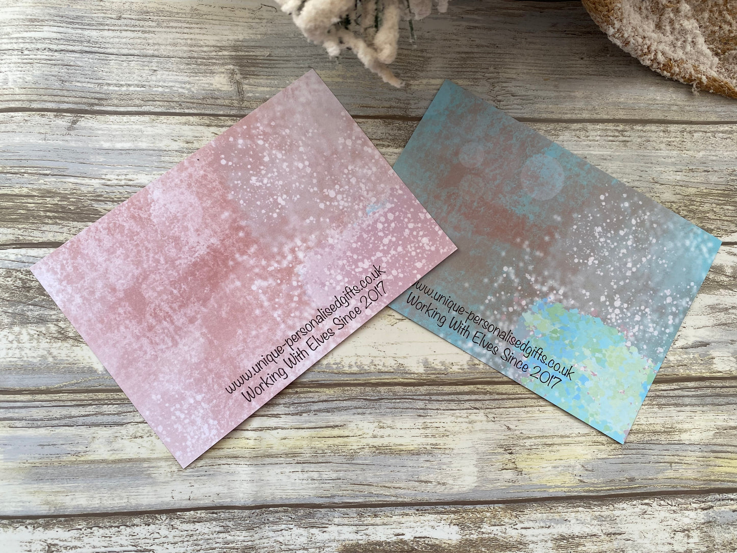 Two scratch cards on a wooden surface.