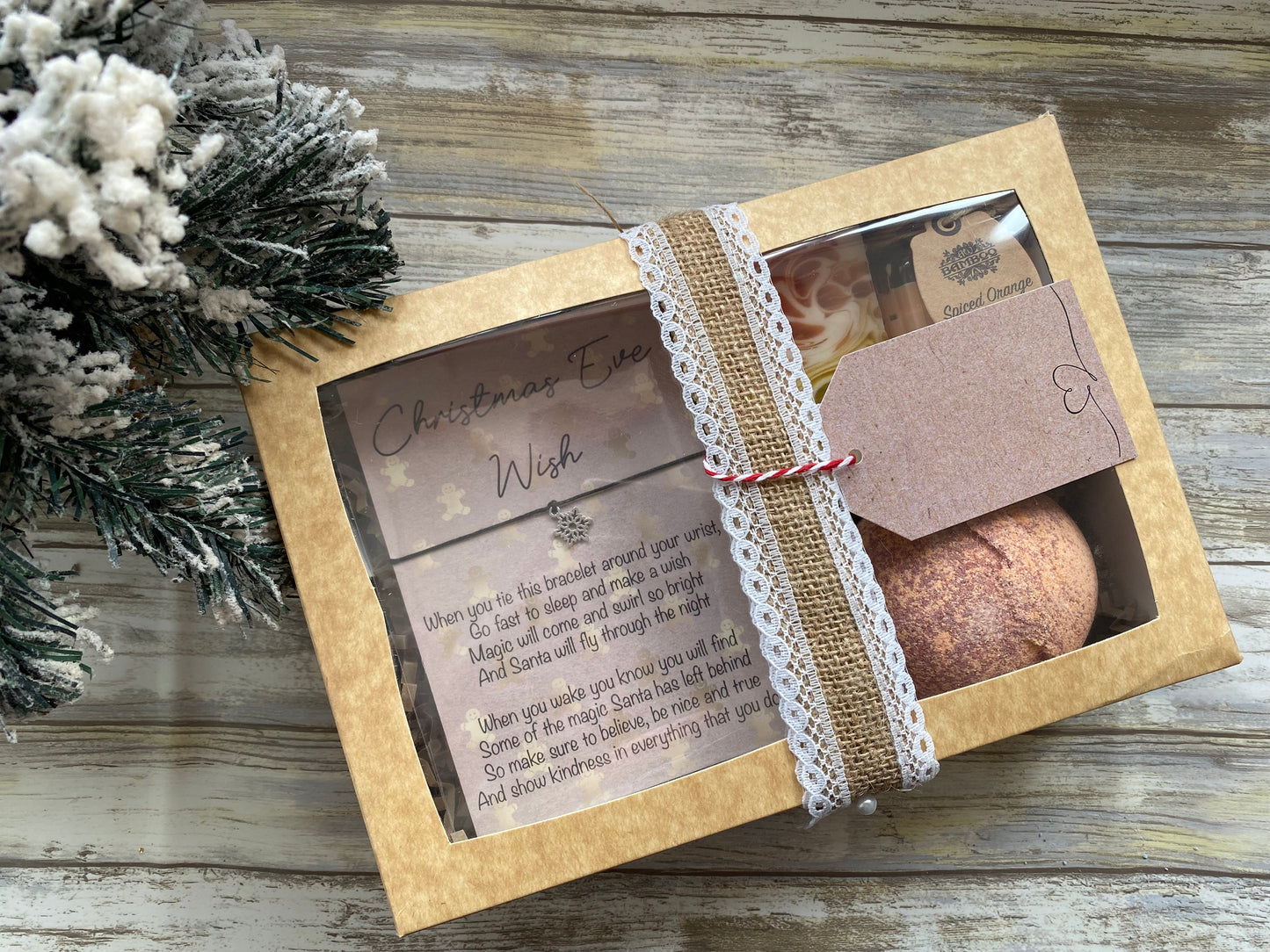 Gift box with bath bomb and decorative text on a wooden surface