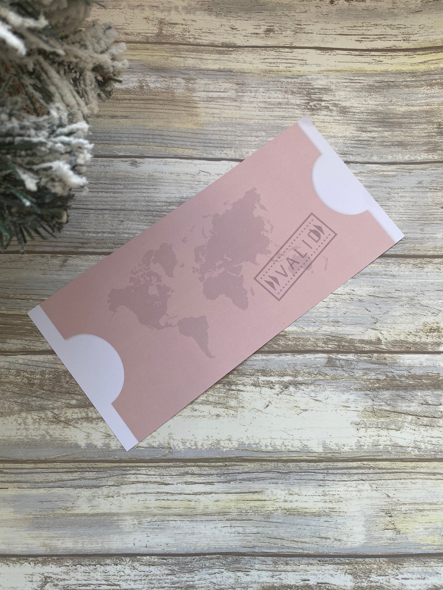 Pink card with floral design and 'WILLOW' branding on a wooden surface