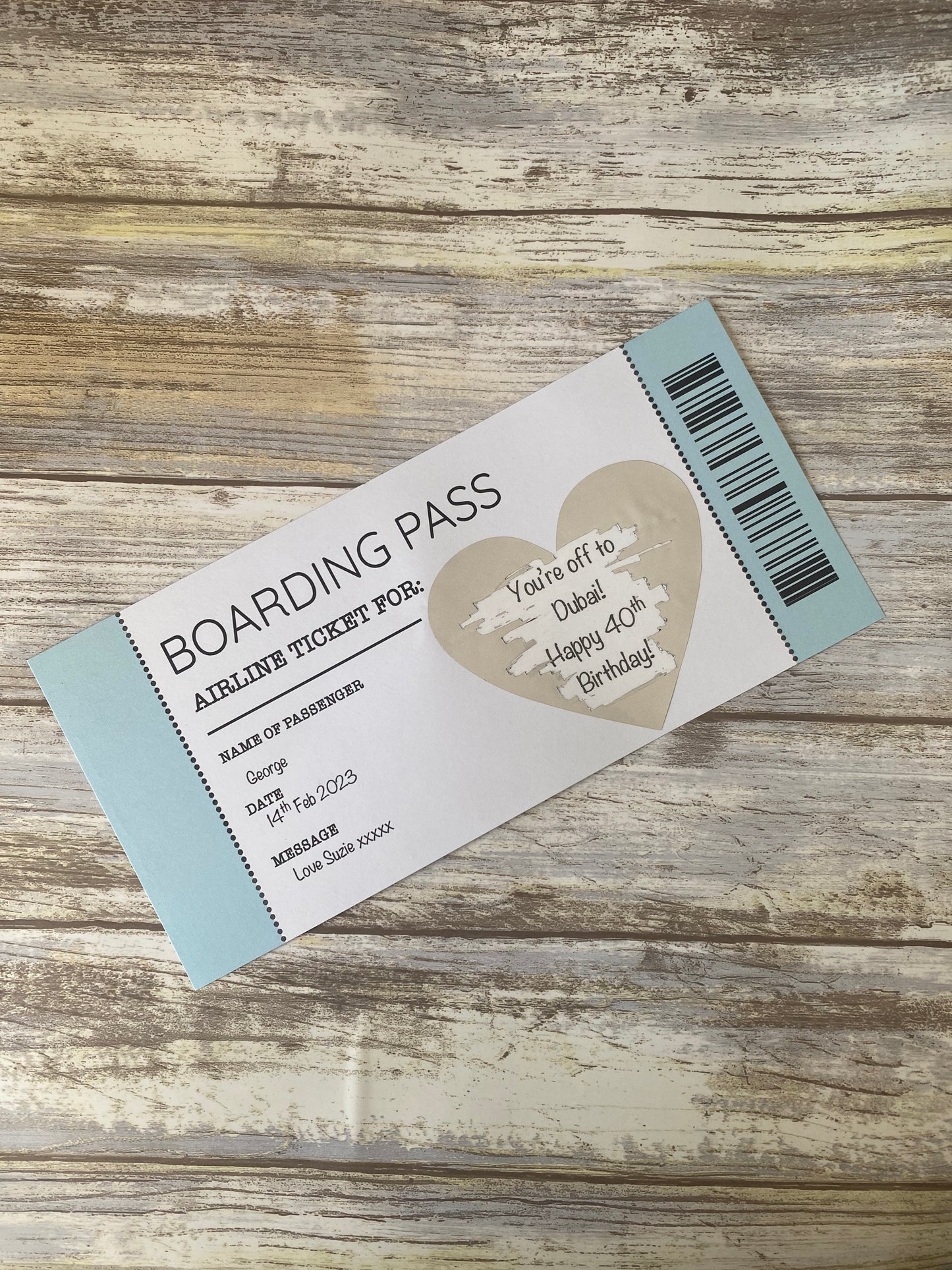 Boarding pass-style birthday invitation on a wooden surface