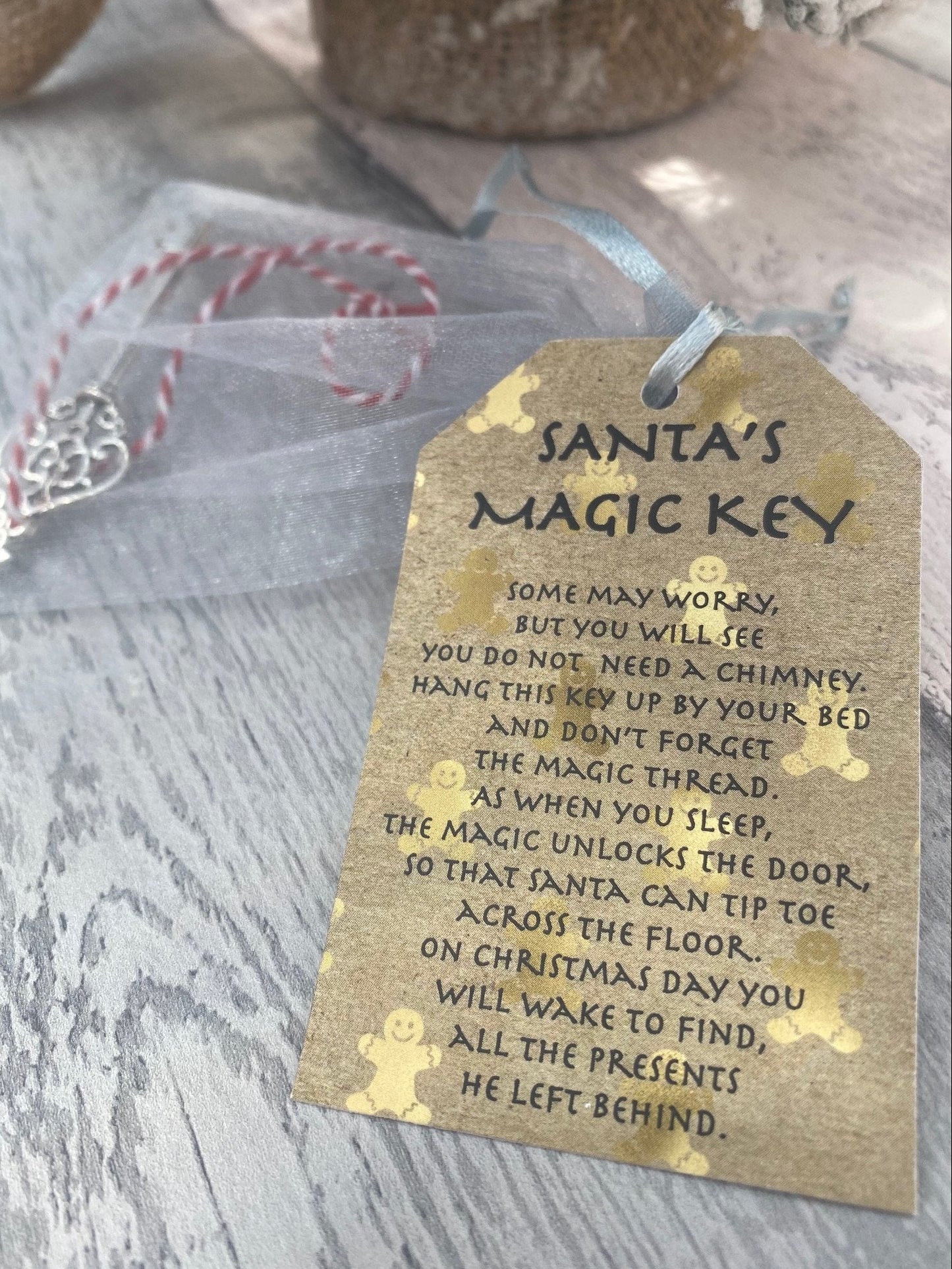 Tag with 'Santa's Magic Key' poem on a wooden surface