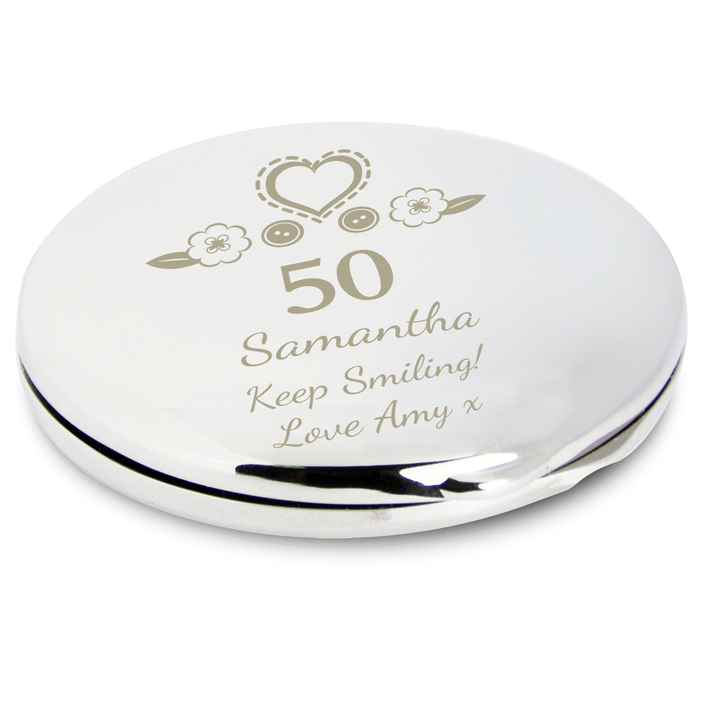 Round silver compact mirror with engraved text and decorative elements on a white background
