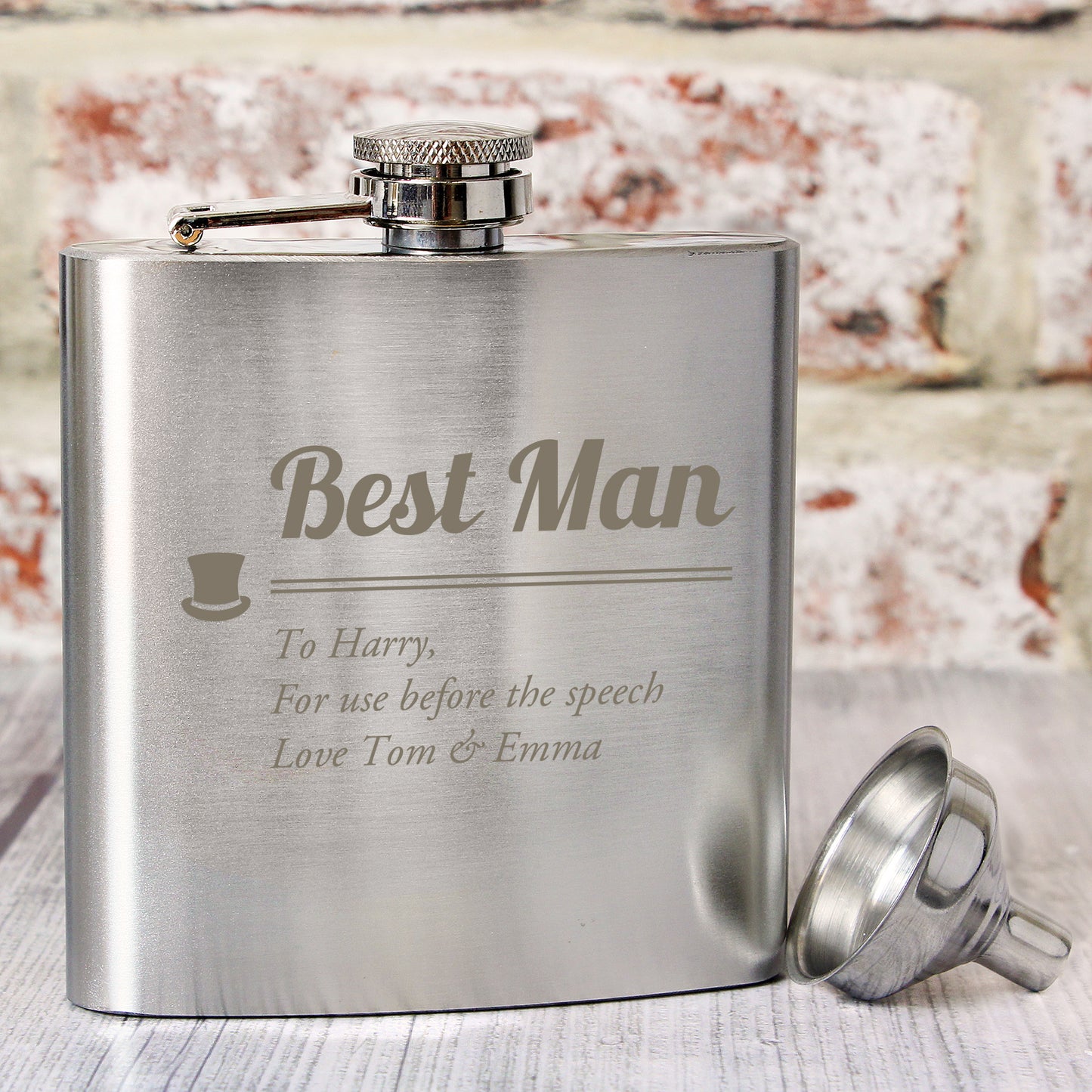 Stainless steel flask engraved with 'Best Man' and personalized text, on a wooden surface.