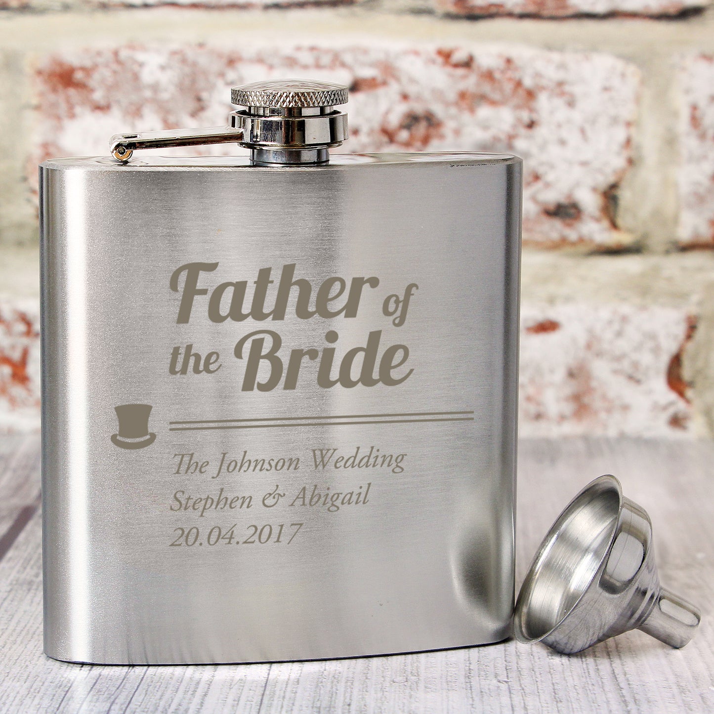 Stainless steel flask engraved with 'Father of the Bride' text and personalised details on a textured surface.