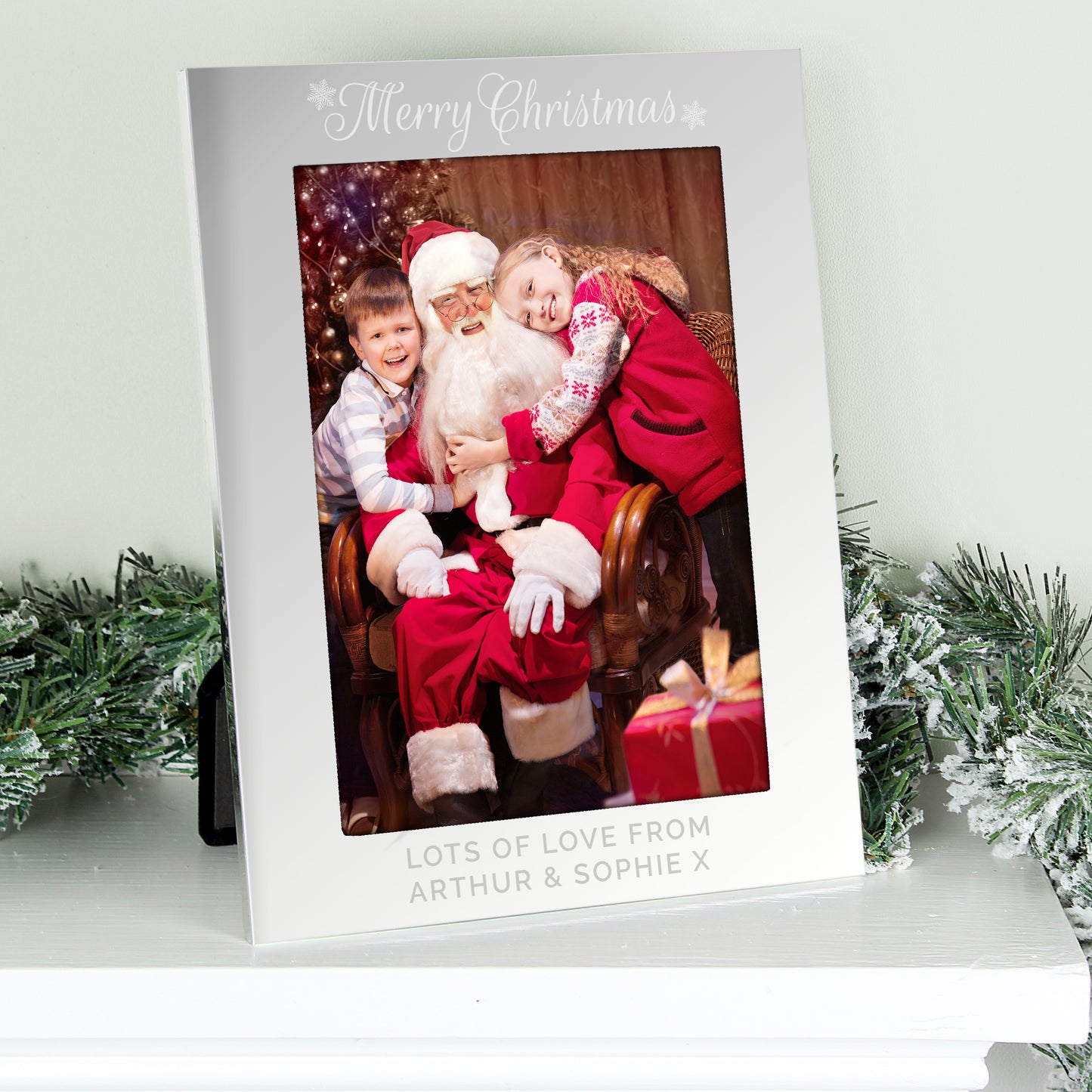 Personalised Christmas card with a photo of Santa Claus and two children, surrounded by festive decorations.