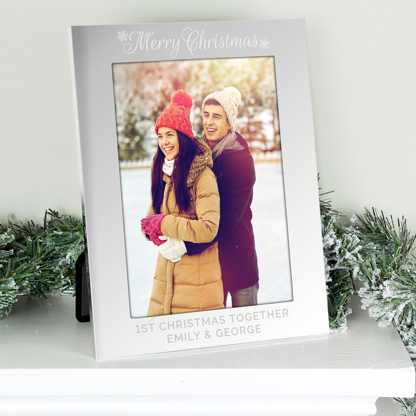 Personalised photo frame with a couple's photo and 'Merry Christmas' text, surrounded by festive decorations.