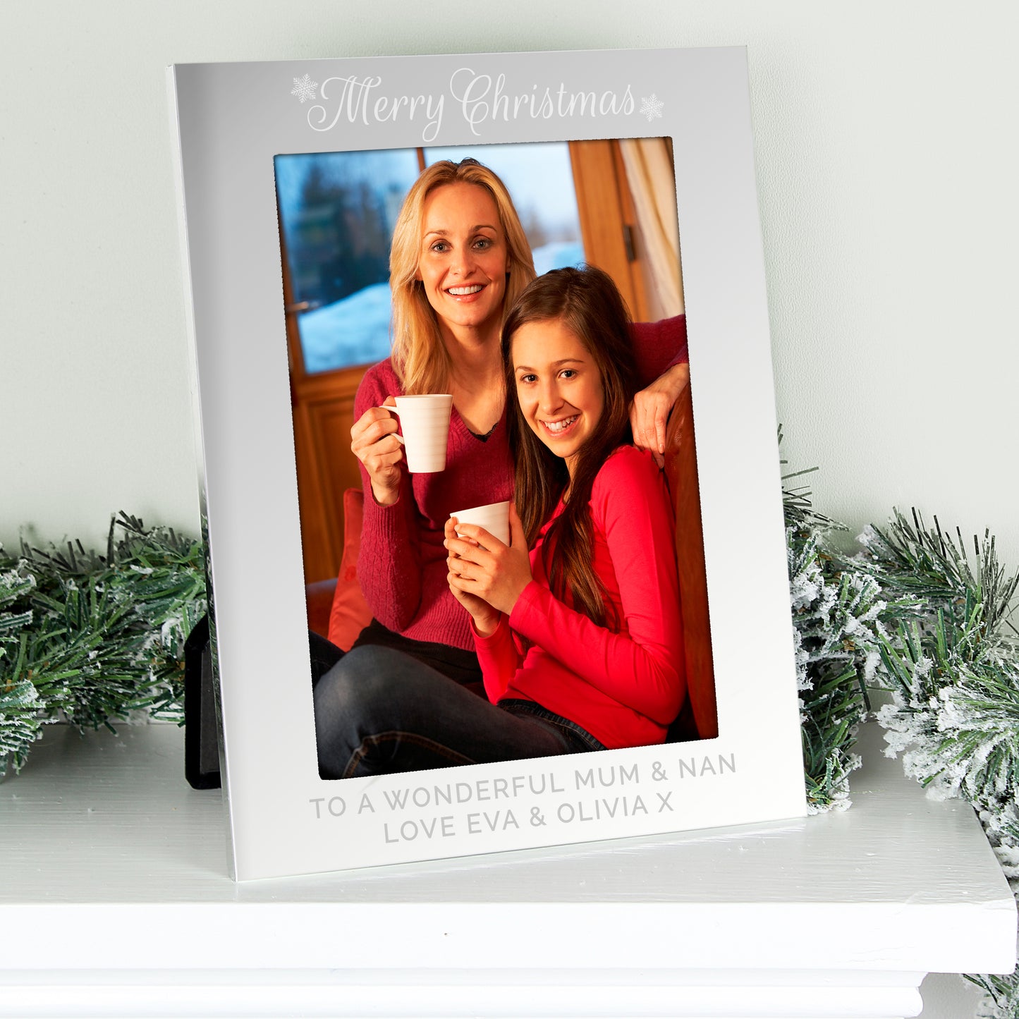 Personalised photo frame with a Christmas message and two people holding mugs.