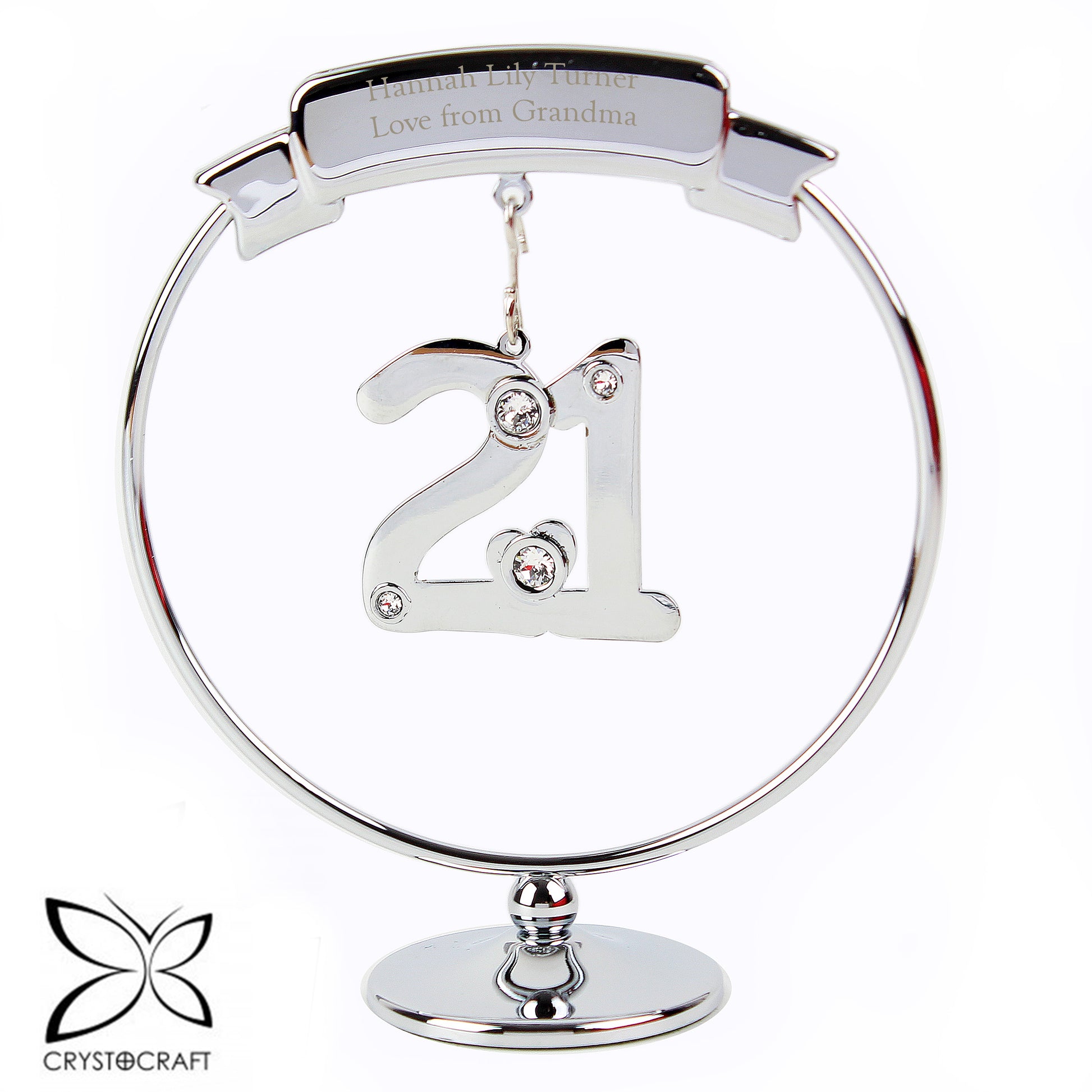 Silver ornament with '21' and engraved text on a white background