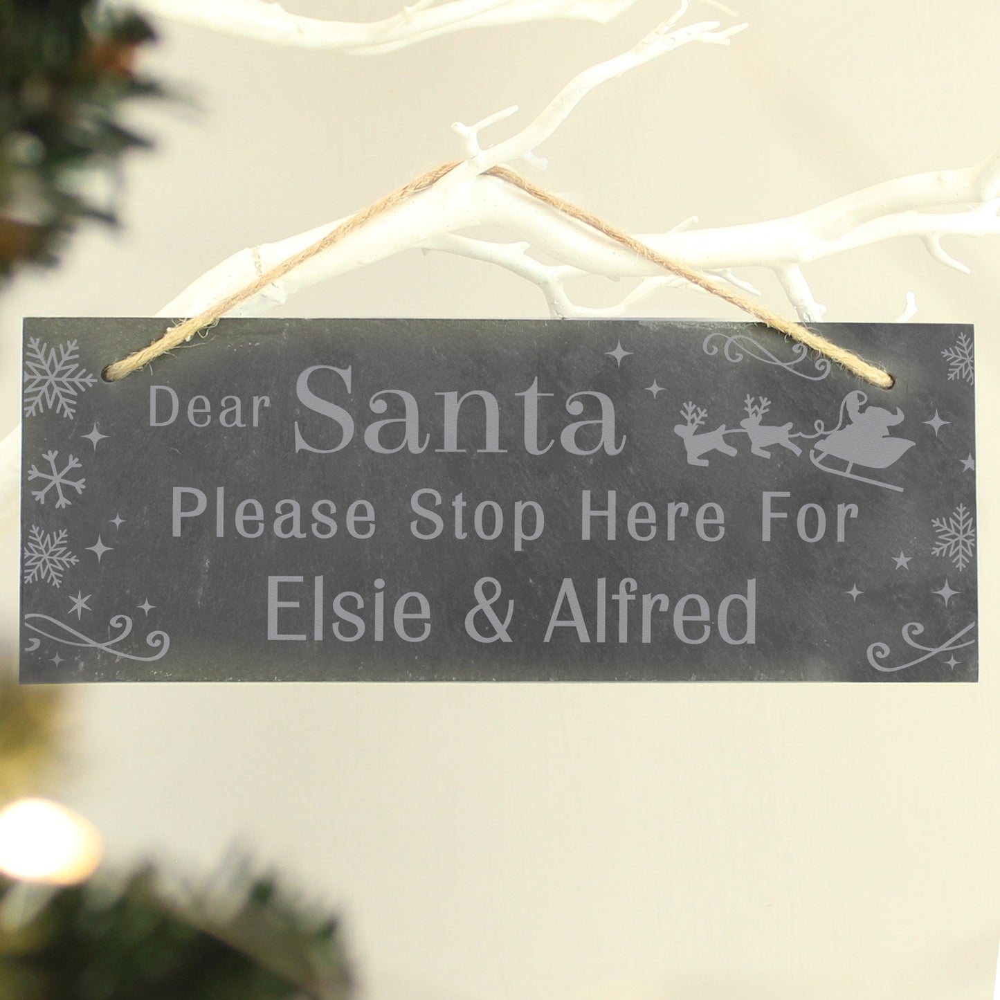 Decorative sign for Christmas with text 'Dear Santa Please Stop Here For Elsie & Alfred' on a tree.
