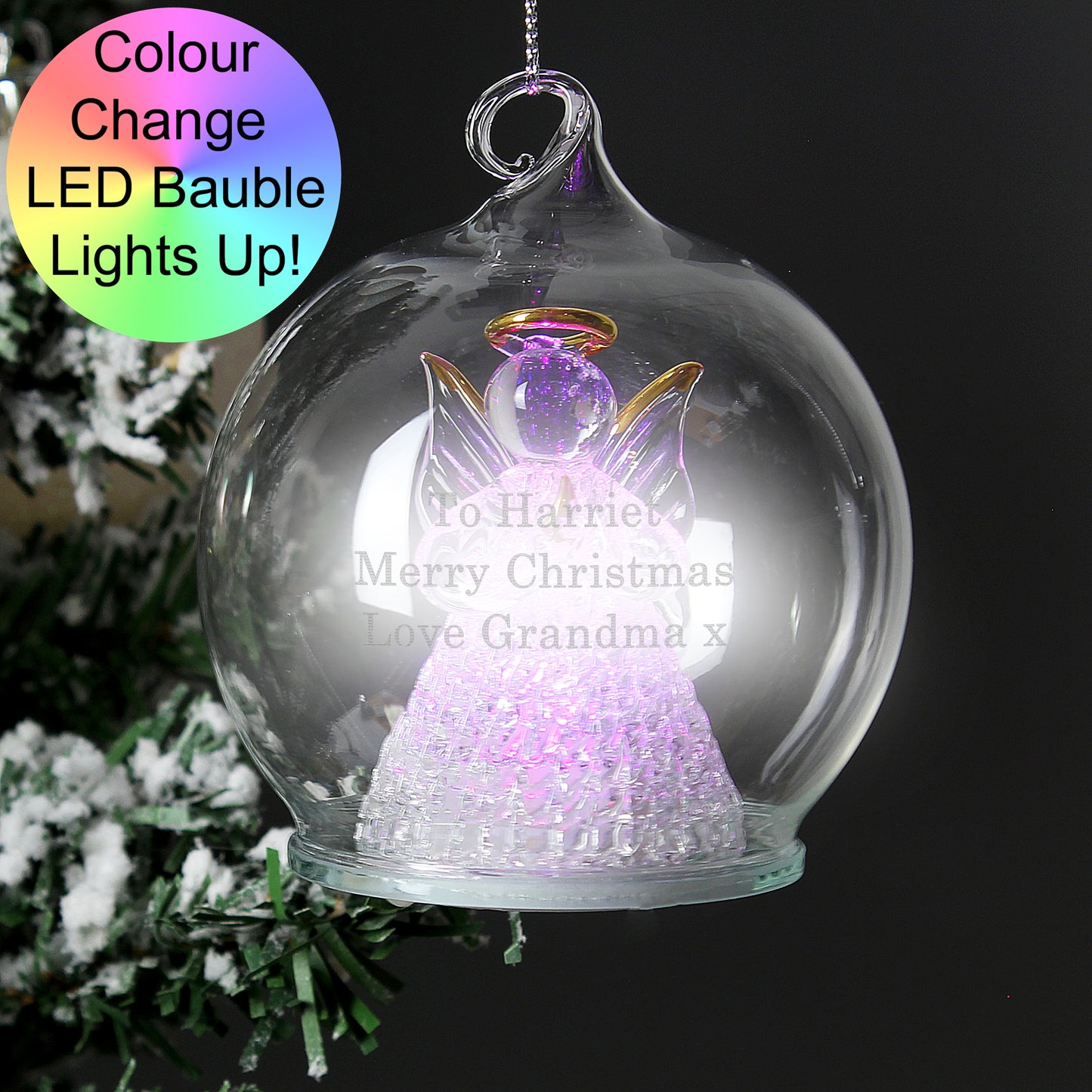 Color-changing LED bauble with angel design on a Christmas tree.