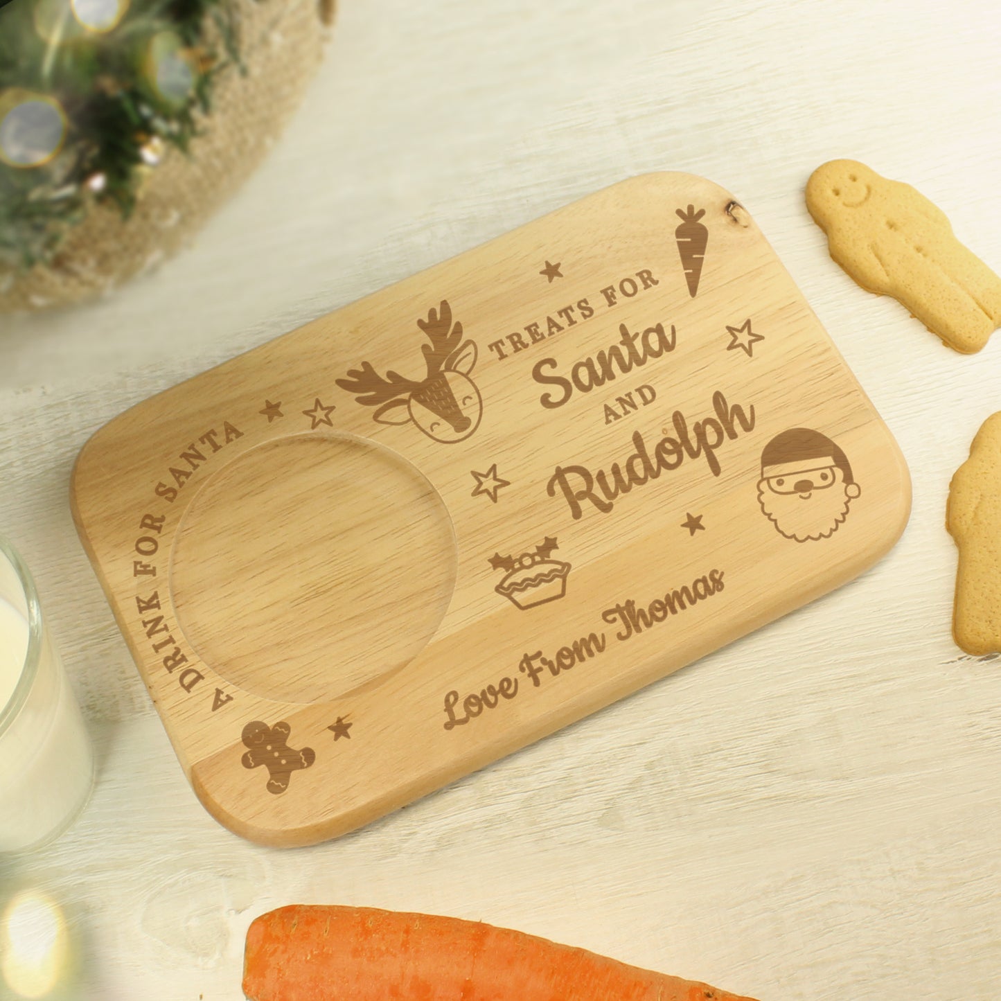 Wooden tray with engraved text for Santa and Rudolph, surrounded by Christmas cookies and a carrot.