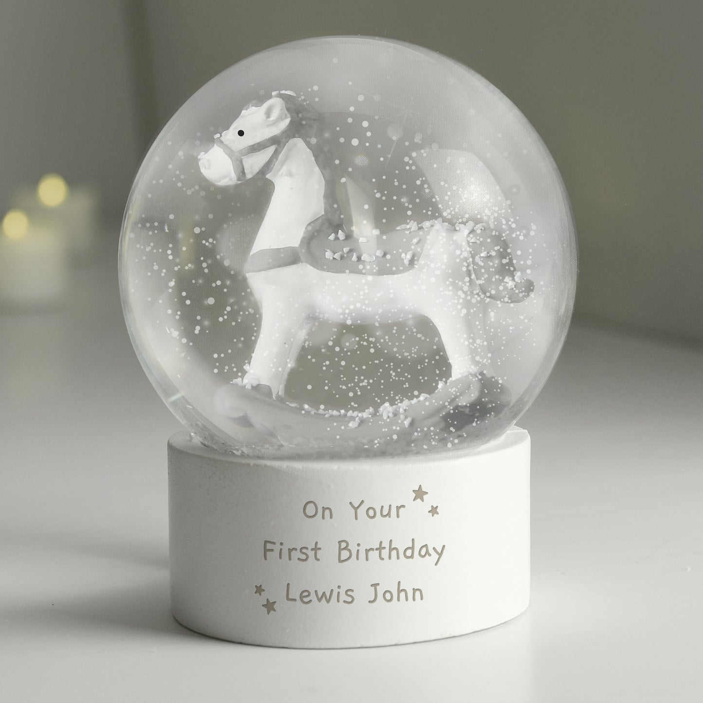 Personalised snow globe with a horse figure and engraved text on a neutral background