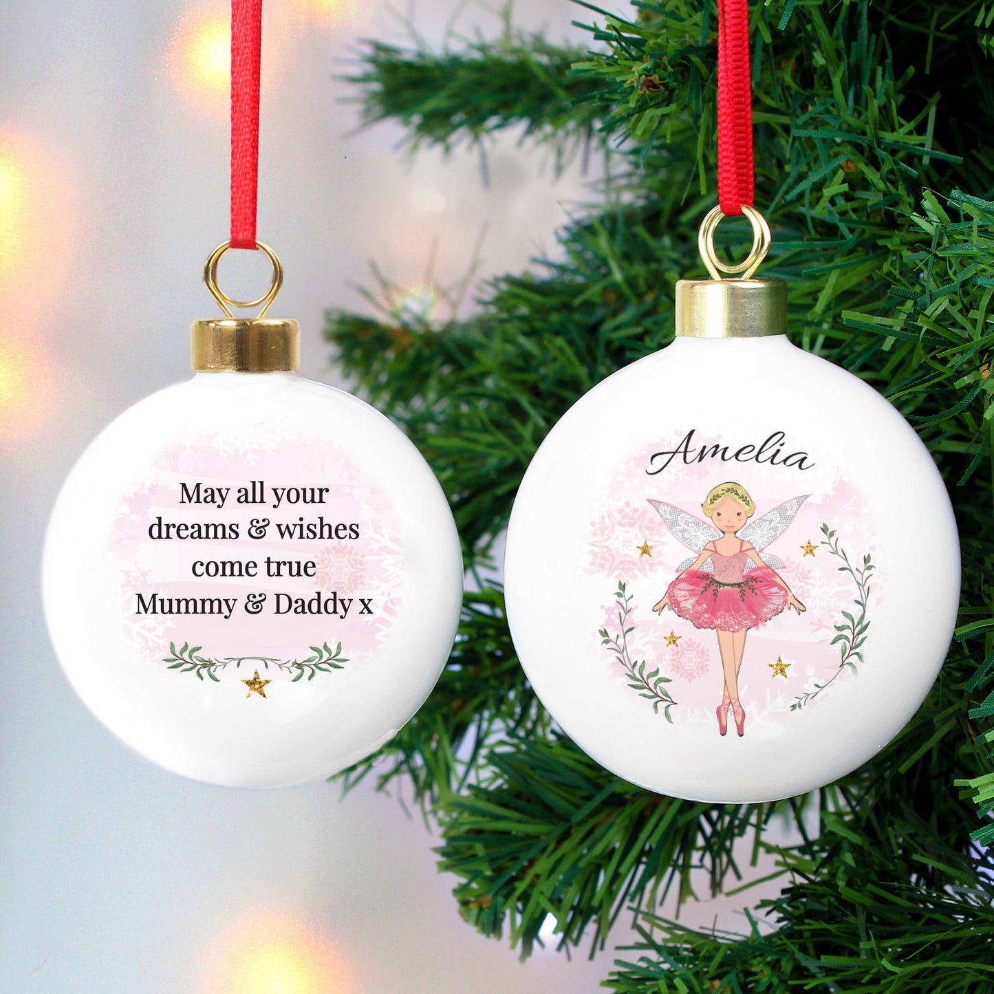 Christmas ornaments with fairy design and personalised text on a tree.