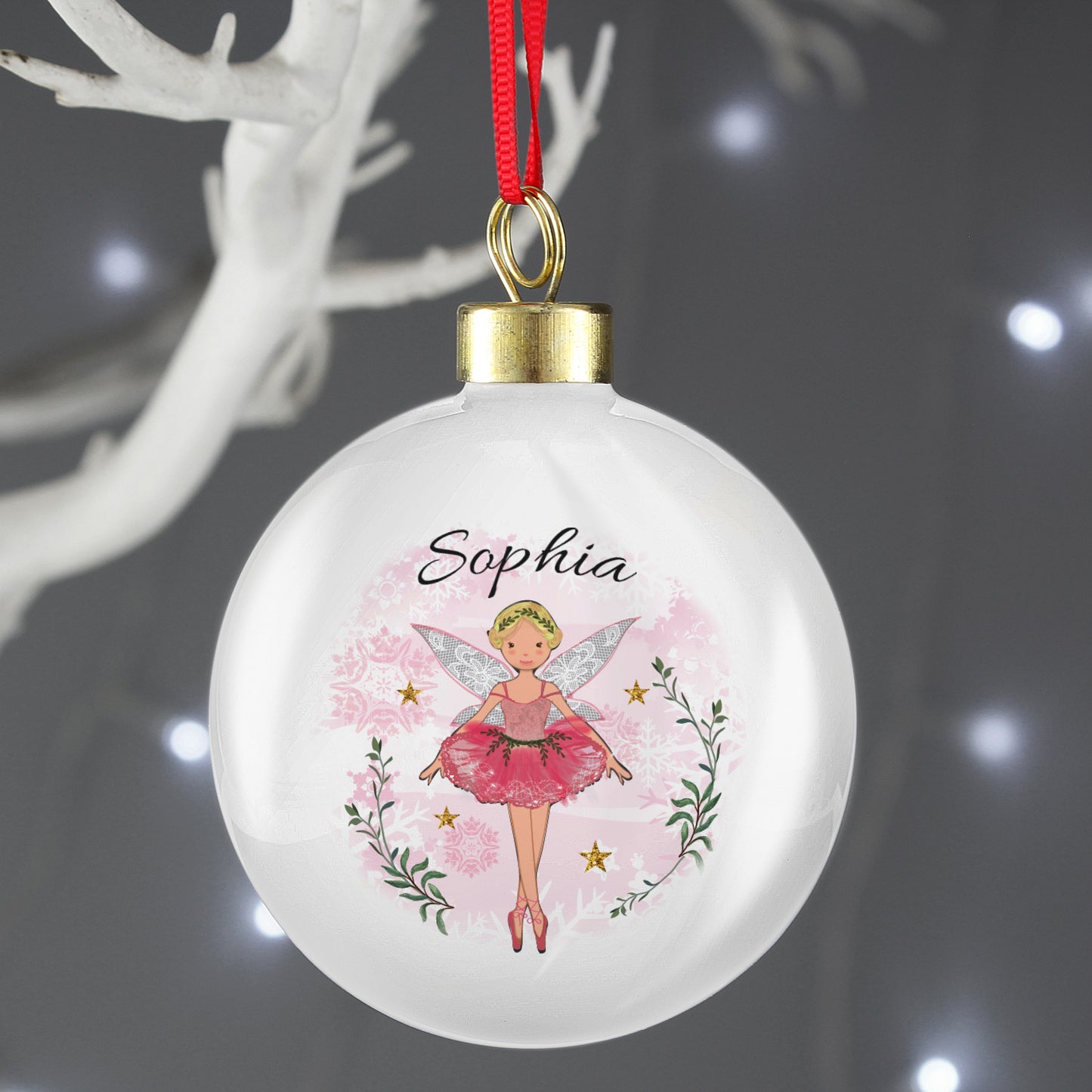 Decorative Christmas ball ornament with a fairy design and the name 'Sophia' on a dark background.