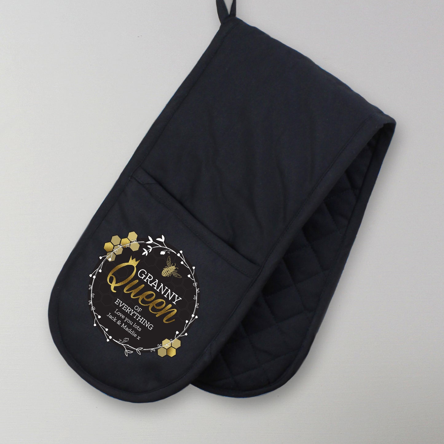 Personalised Black oven mitt with 'Granny Queen' text on a grey background