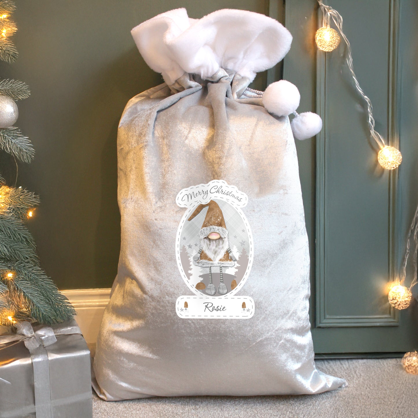 Decorative Santa sack with a label featuring a gnome, Christmas tree, and presents in the background.