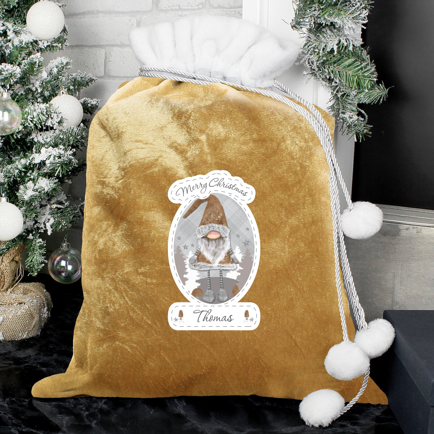 Personalised Gold velvet drawstring bag with Christmas-themed design and tree in the background