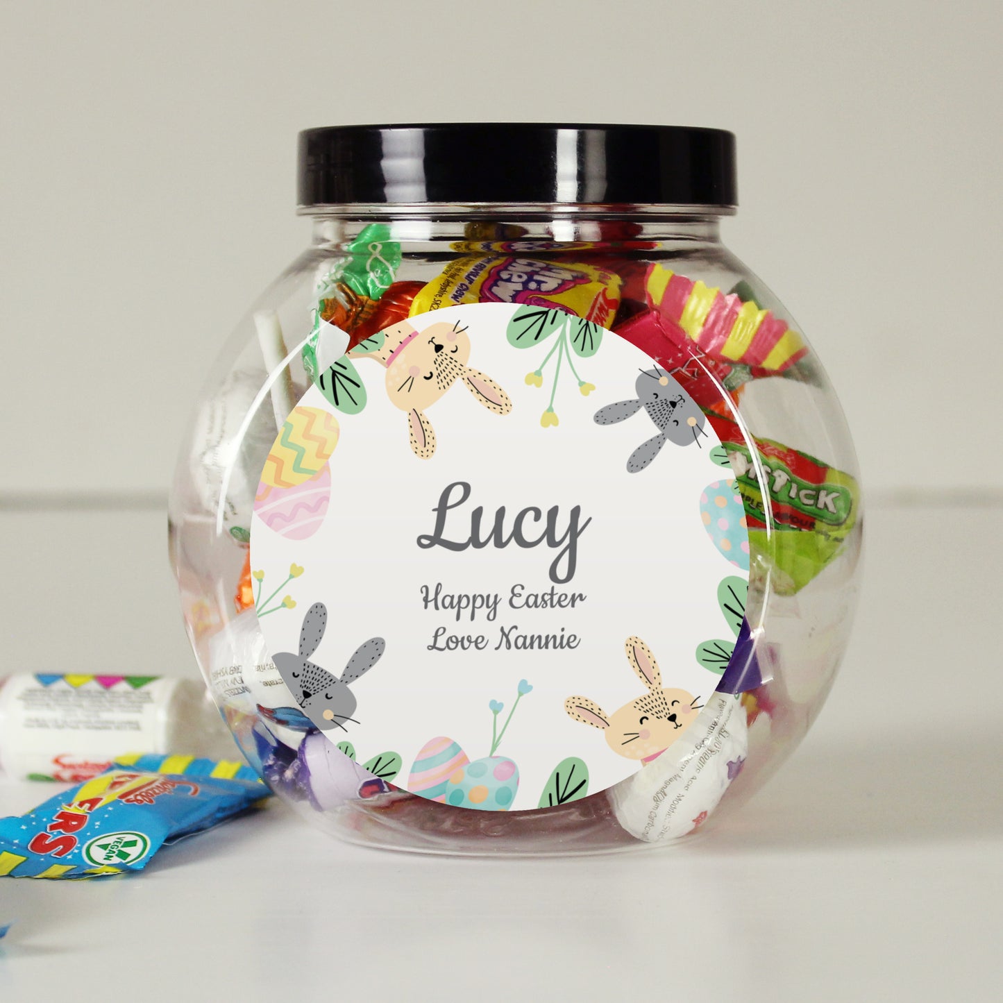 Personalised Easter candy jar with colourful candies and a label reading 'Lucy Happy Easter Love Annie'.