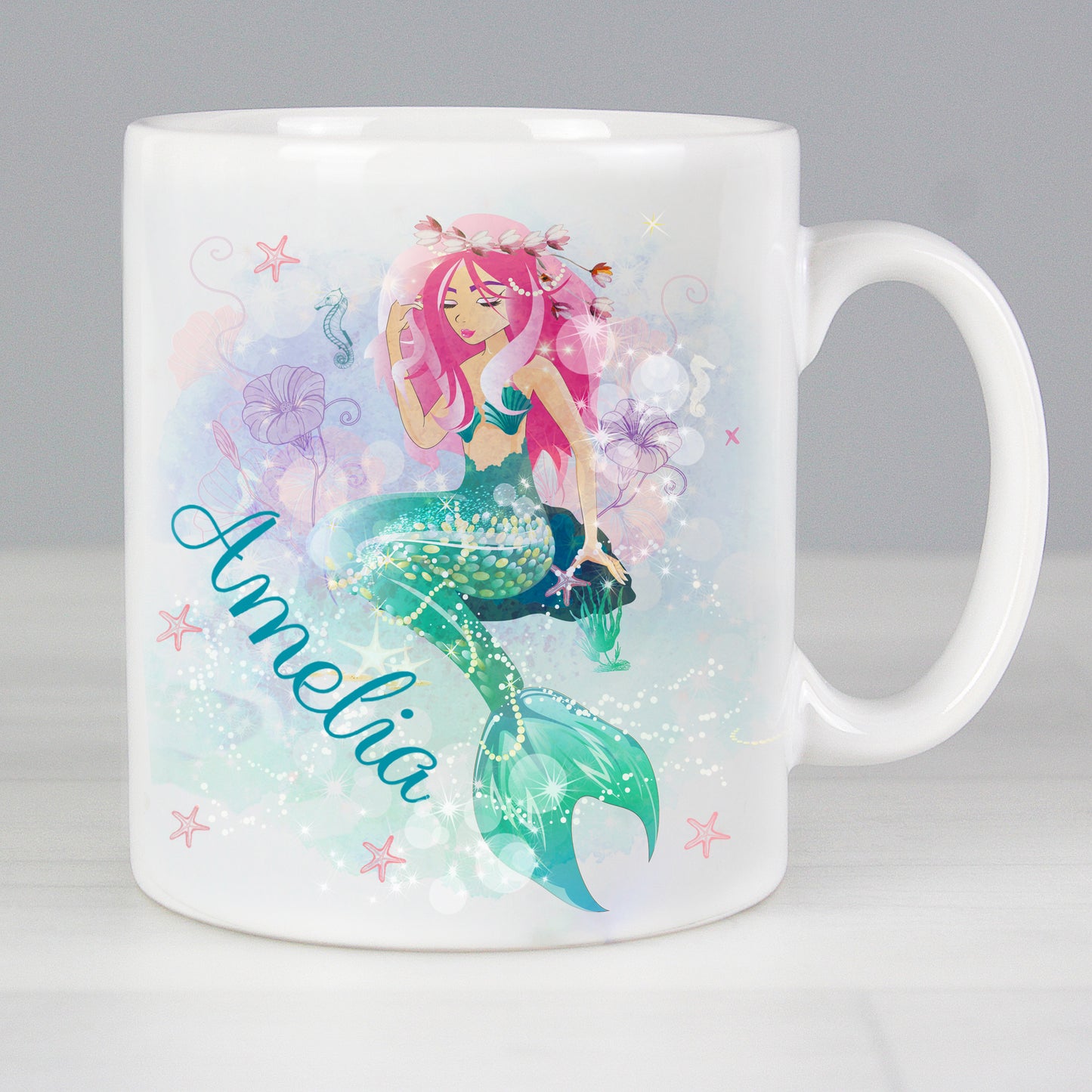 Mug with a mermaid design and the name 'Amelia' on a grey background