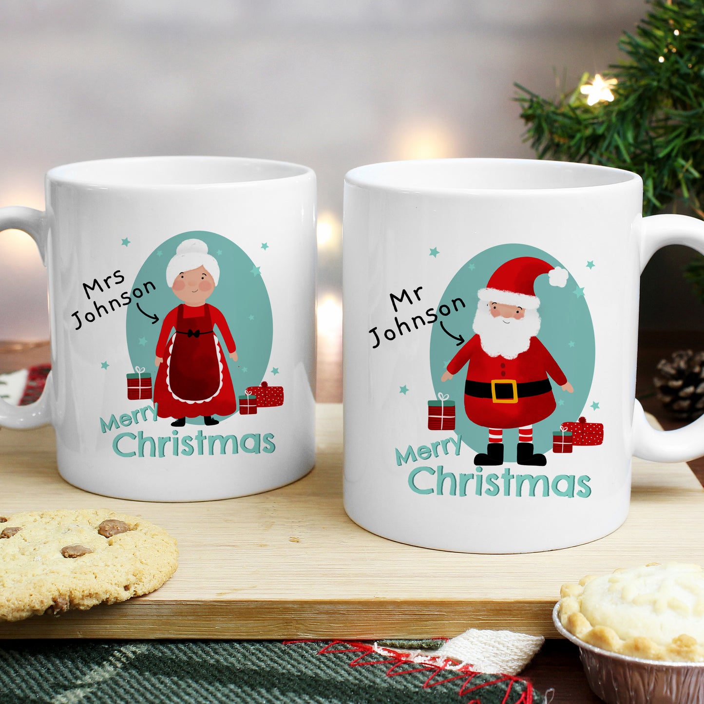 Two Christmas-themed mugs with illustrations of Santa Claus and Mrs. Claus on a festive background.
