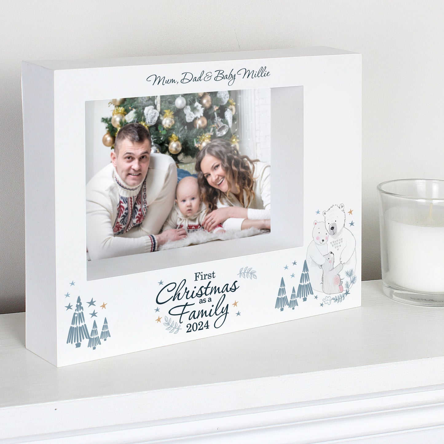 Personalised photo frame with a family photo and Christmas design on a white surface.