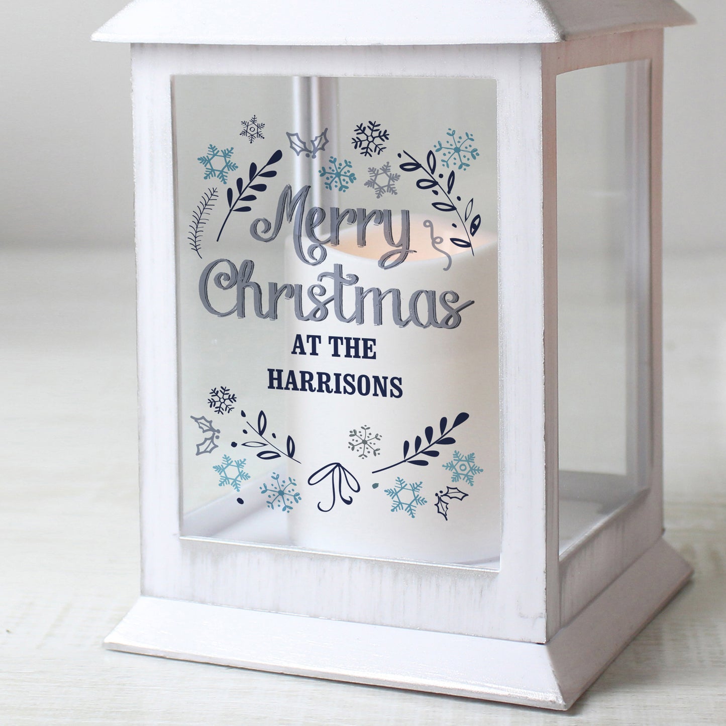 Personalised White lantern with 'Merry Christmas at the Harrisons' text on a light background