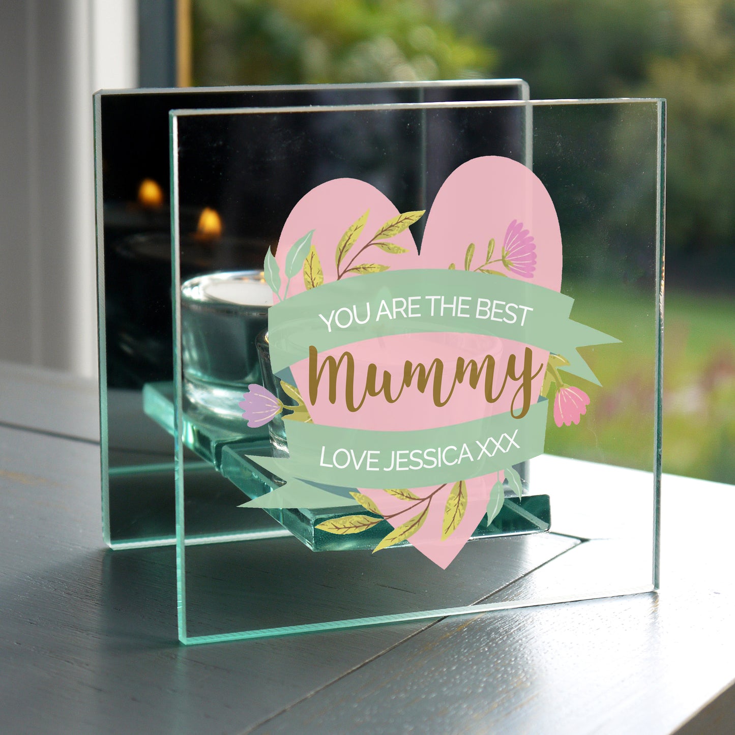 Glass candle frame with floral design and text 'You are the best Mummy' on a reflective surface.
