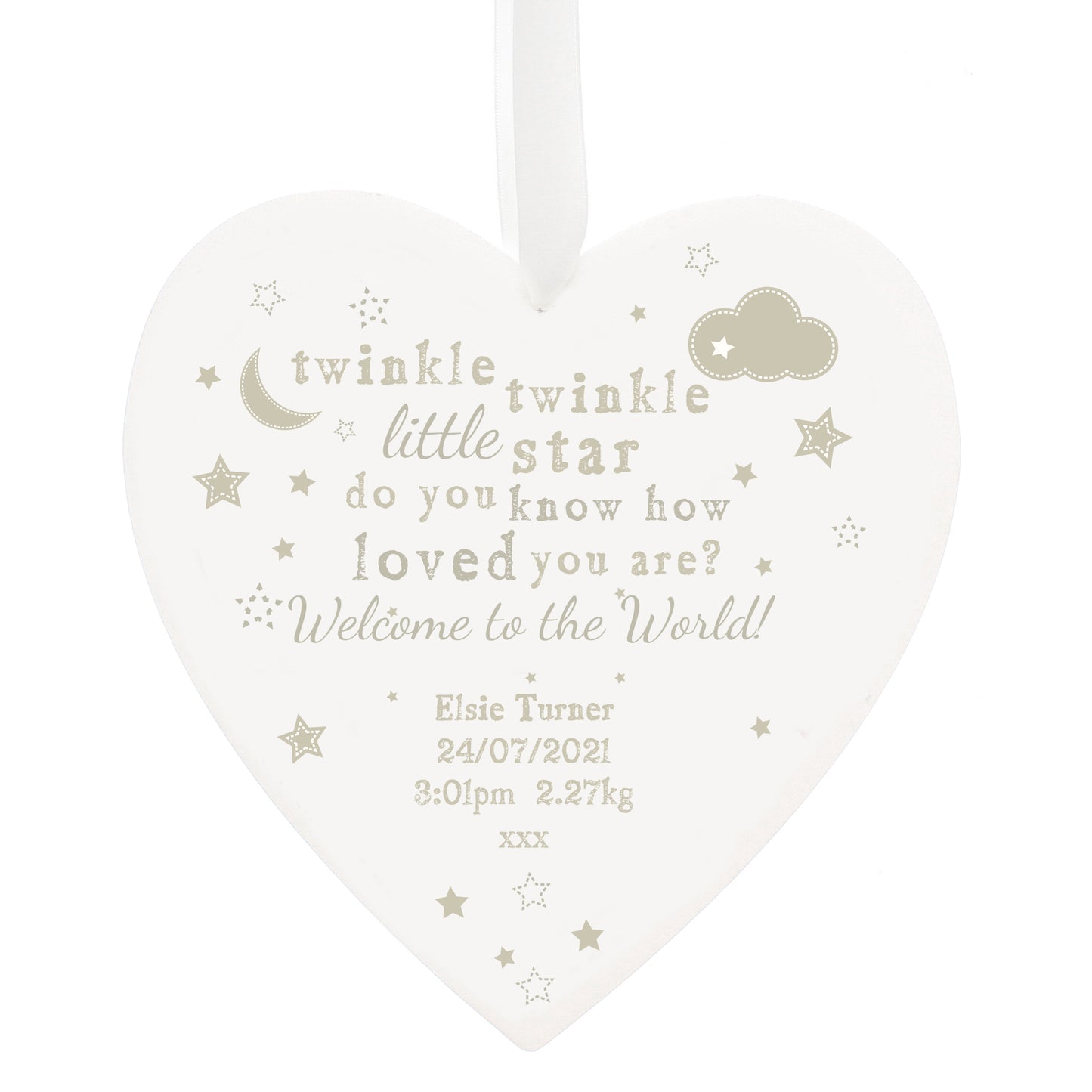 Heart-shaped decorative plaque with baby milestone text on a white background