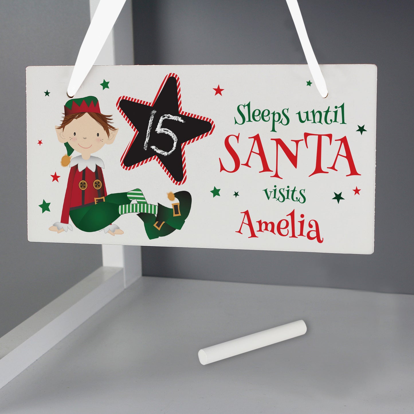 Christmas countdown sign with elf illustration and chalk for writing, on a gray background