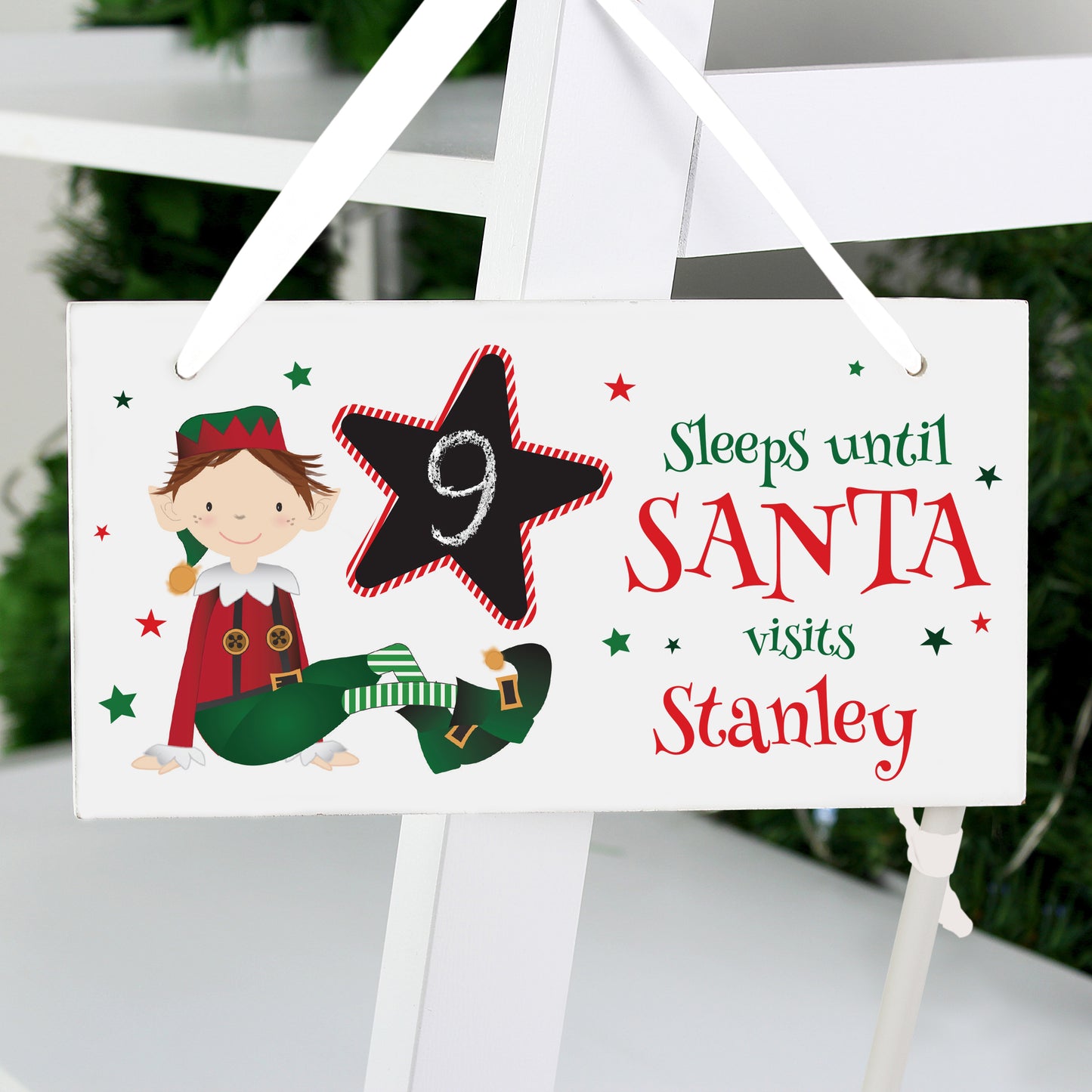 Christmas countdown sign with elf illustration and text