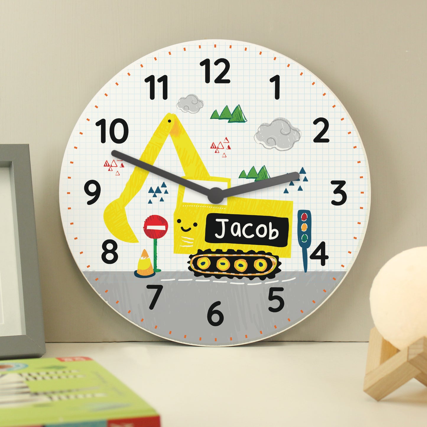Children's wall clock with a yellow excavator design on a light grey background