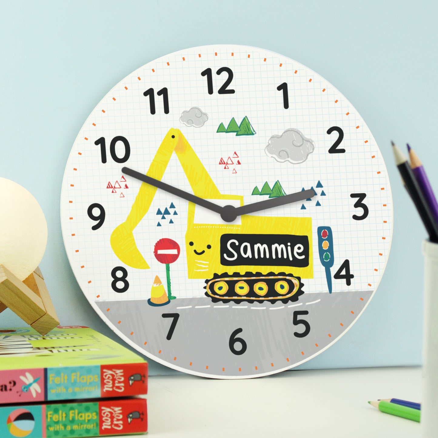 Children's wall clock with a yellow excavator design and the name 'Sammie' on a light blue background.