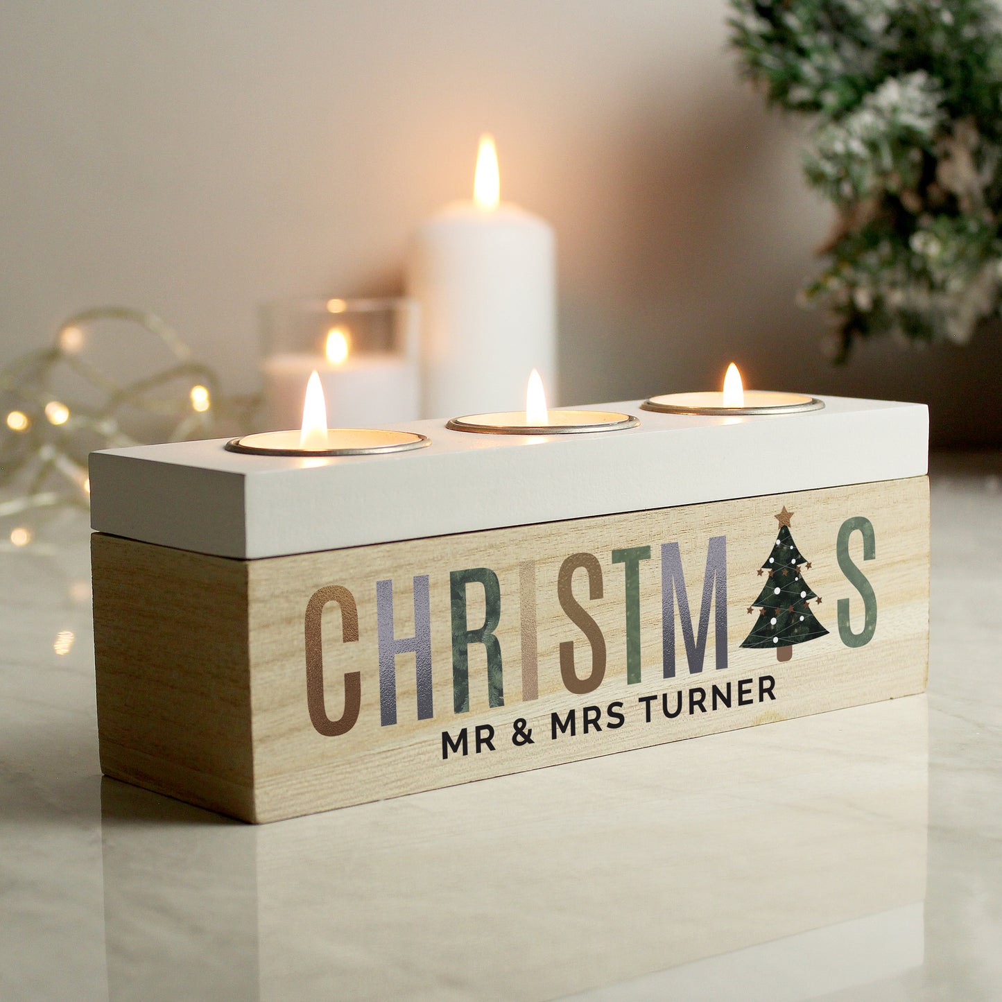 Wooden Christmas candle holder with personalised name on a neutral background