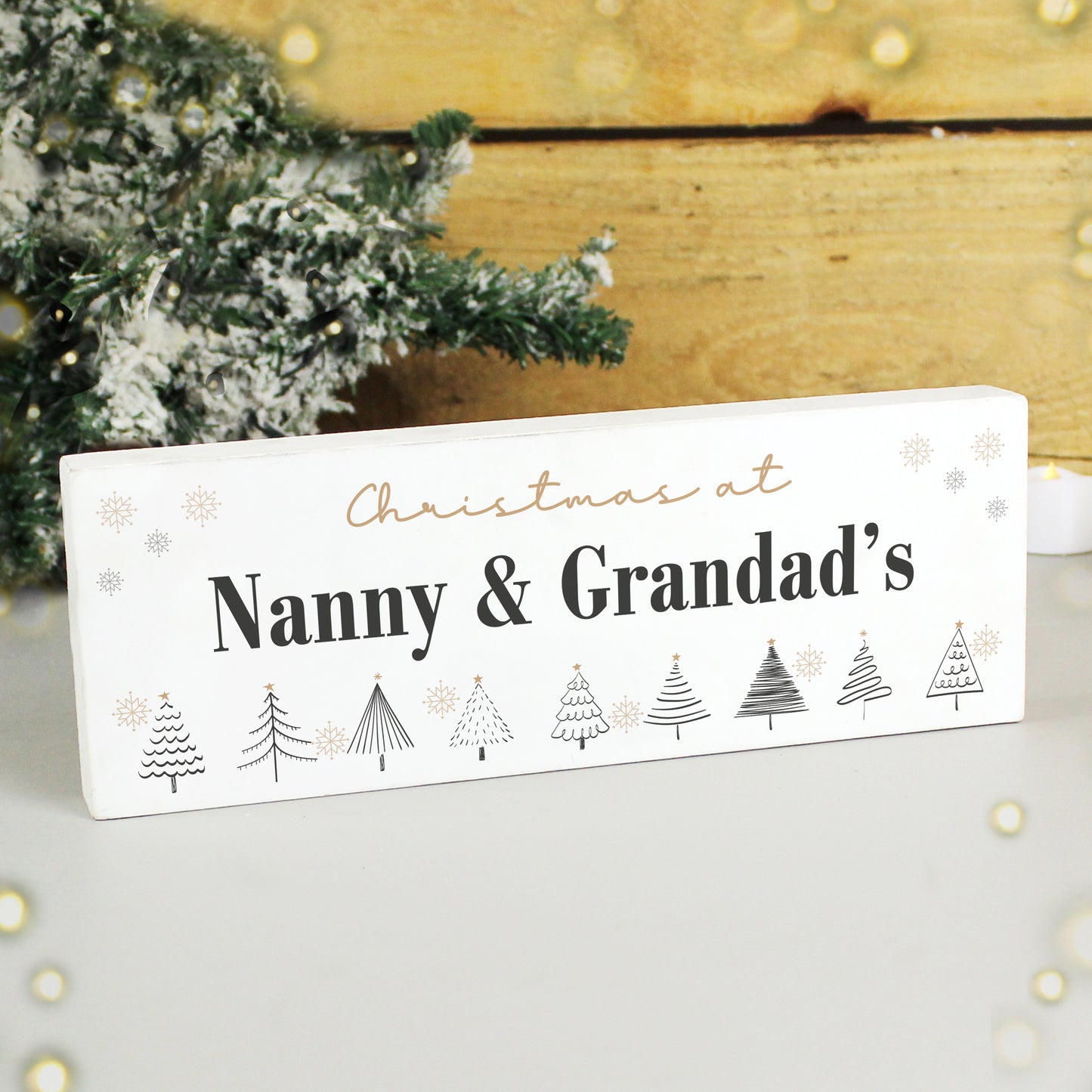 Decorative sign with 'Christmas at Nanny & Grandad's' text and Christmas tree illustrations on a white background.
